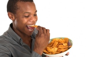 Consumer snacking potato chips