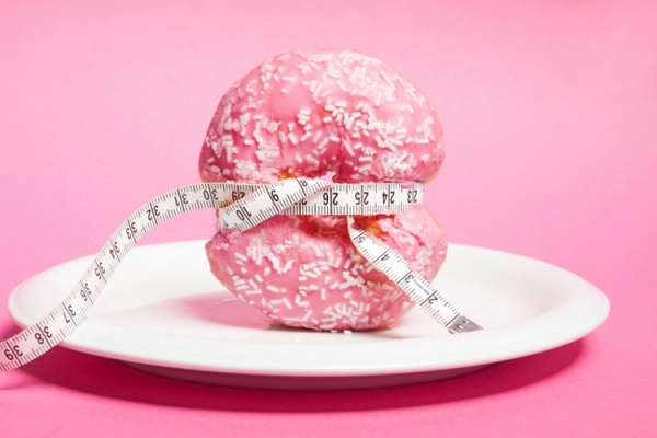 Doughnut with measuring tape Getty