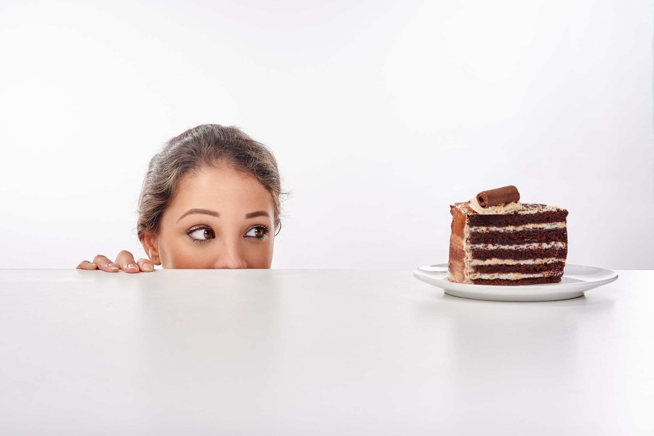 Woman looking at slice of cake on table