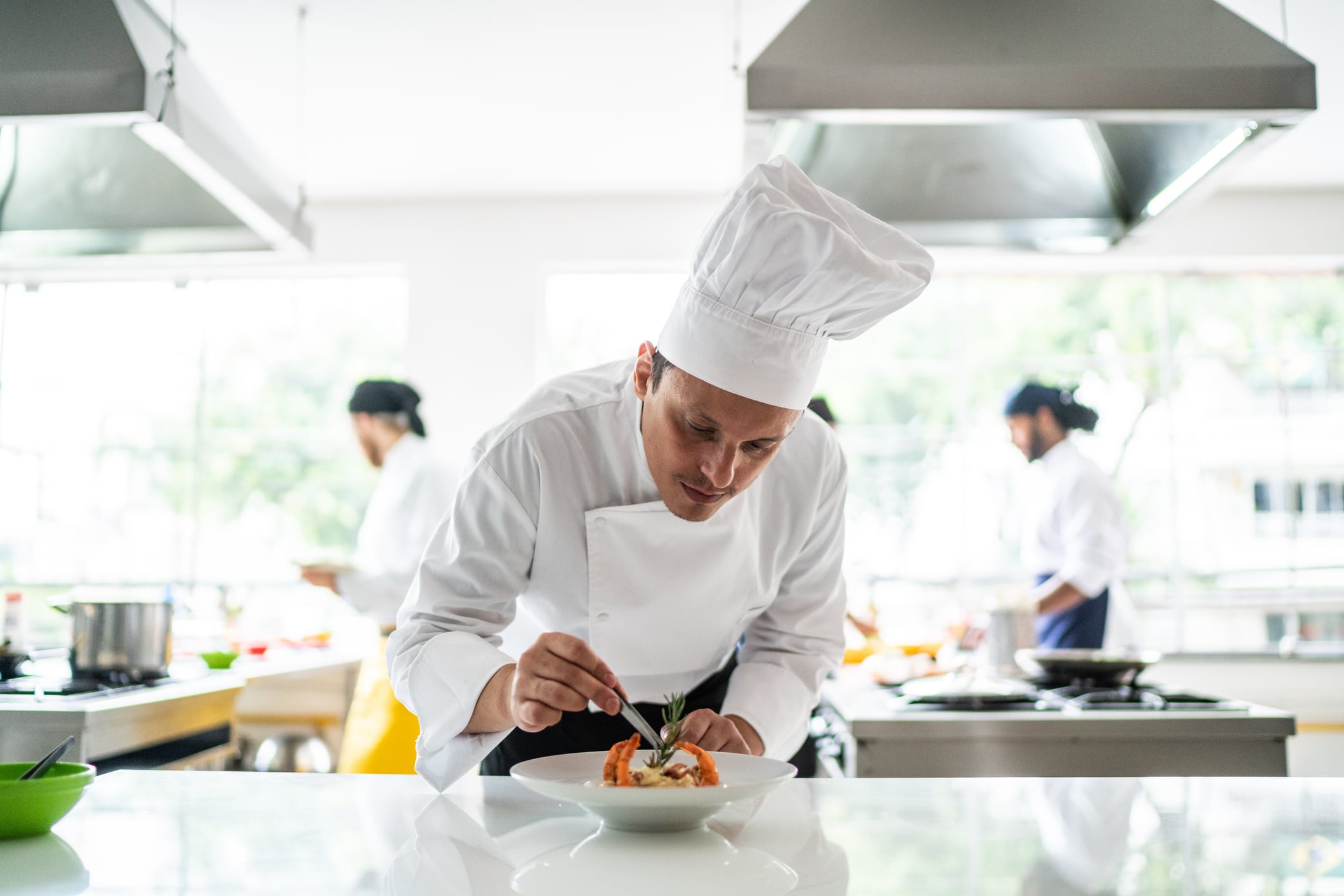 Chef arranging details in a pasta dish