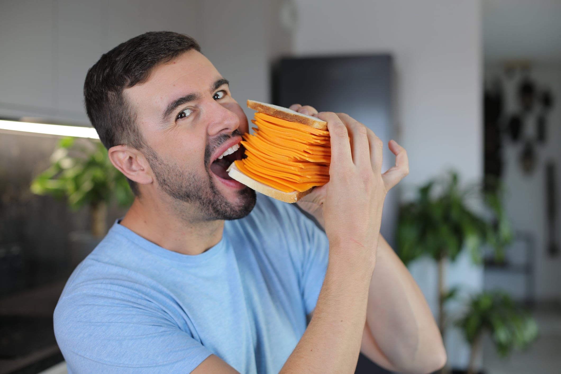 Man eating giant cheese sandwich ajr_images GettyImages