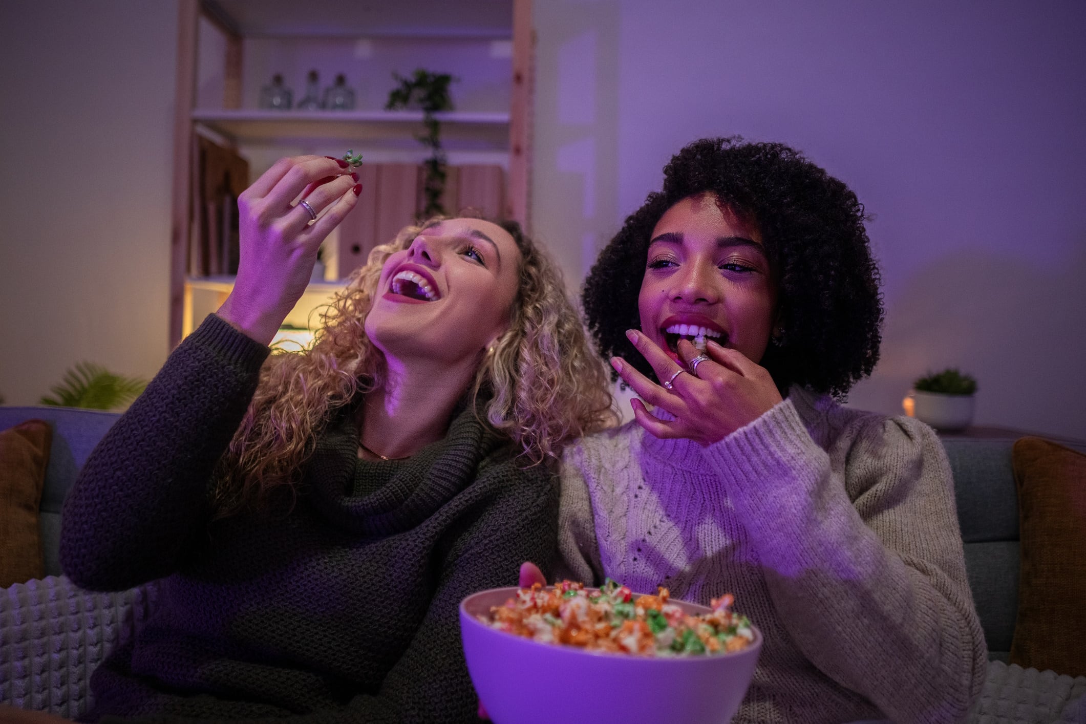 Two Gen Z's snacking on popcorn