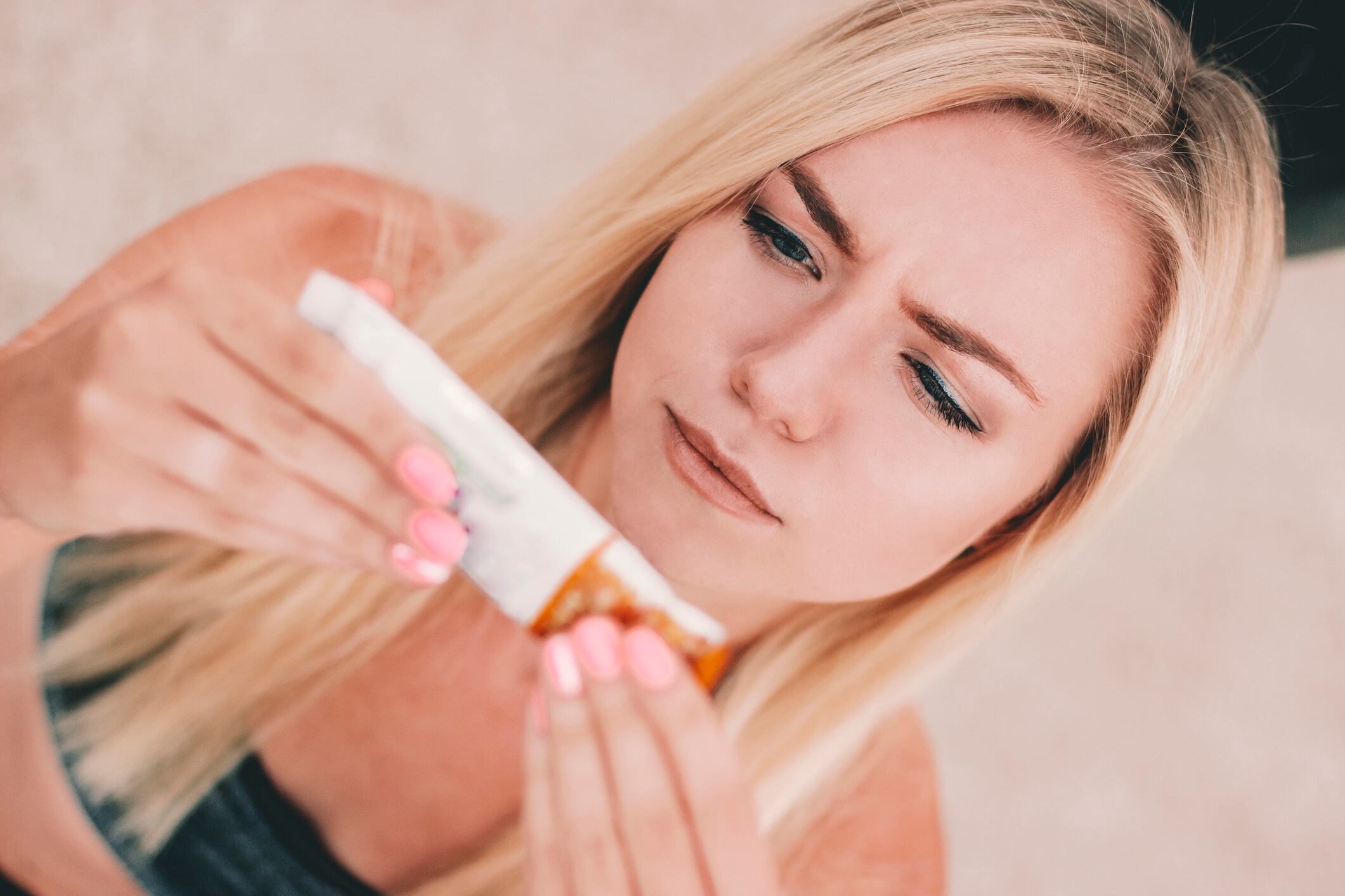 Fitness girl reading label on muesli protein bar