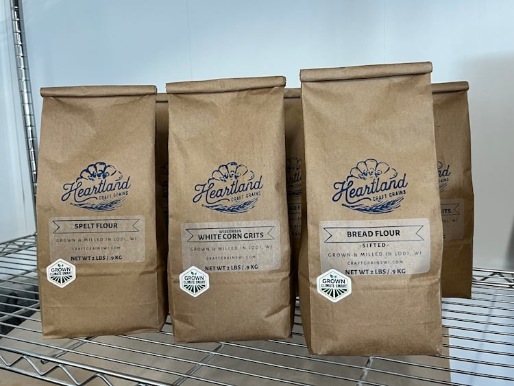 Packs of Heartland Craft Grains' flour with regenerative certification seal