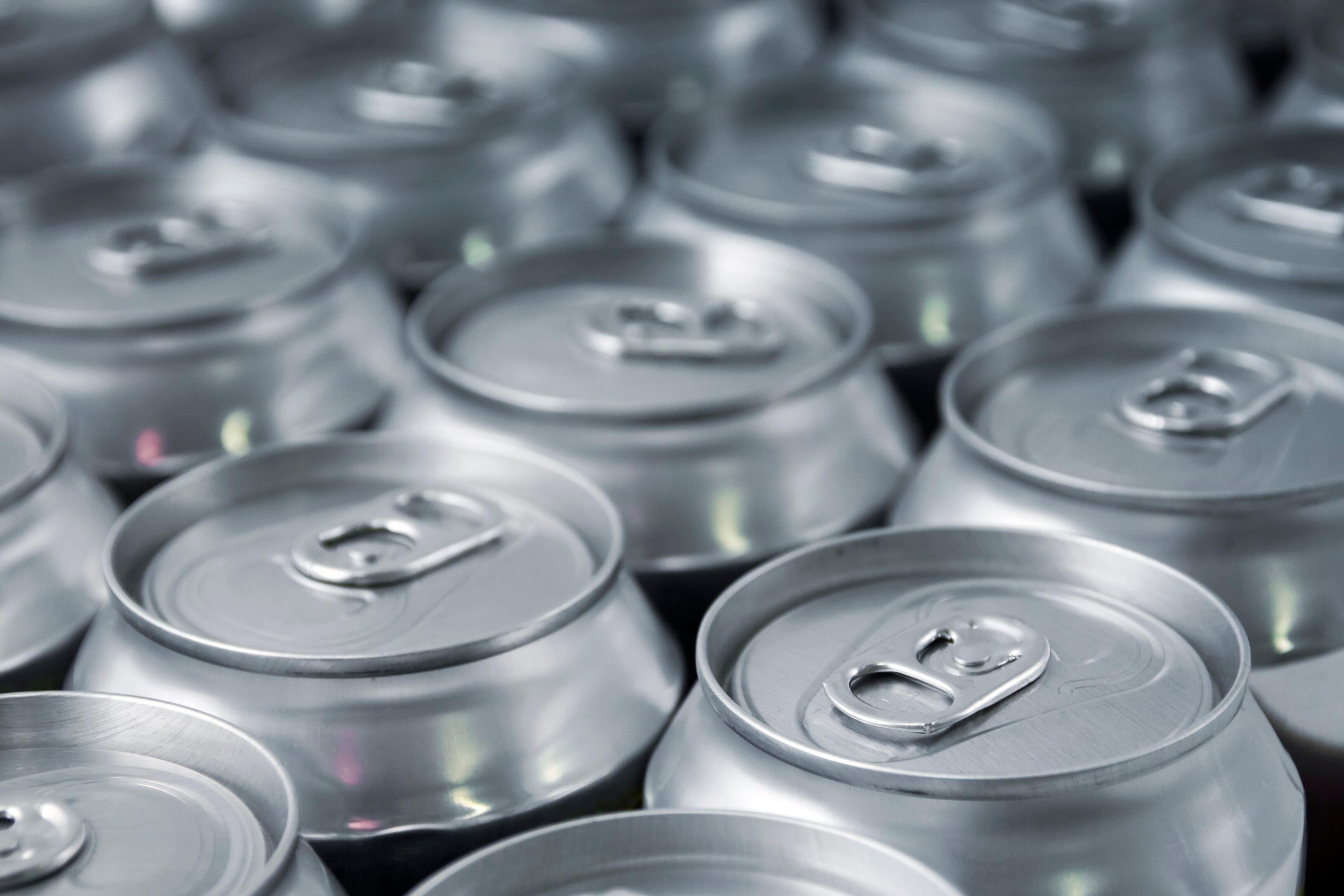 Lots of soda/beer cans in rows. Focus on closest can.Other drink can images: