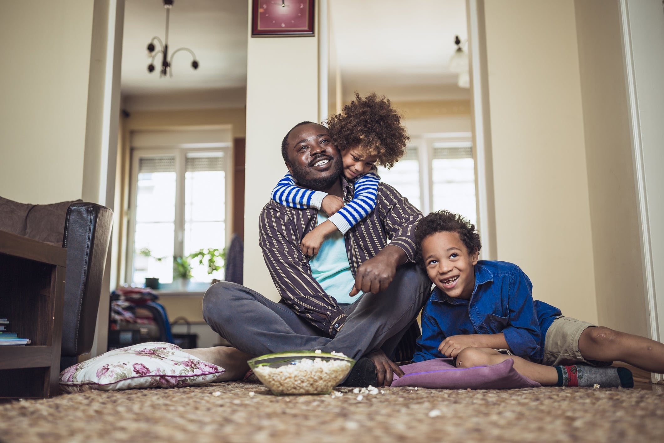 Father watching a movie with his kids