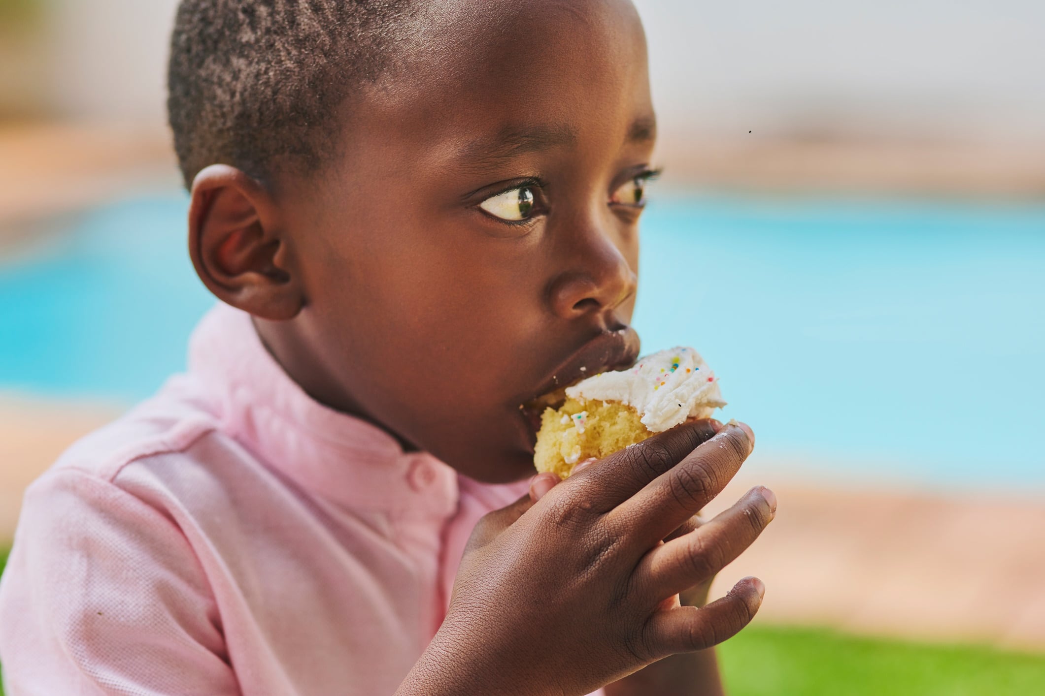 Young African boy eating cake