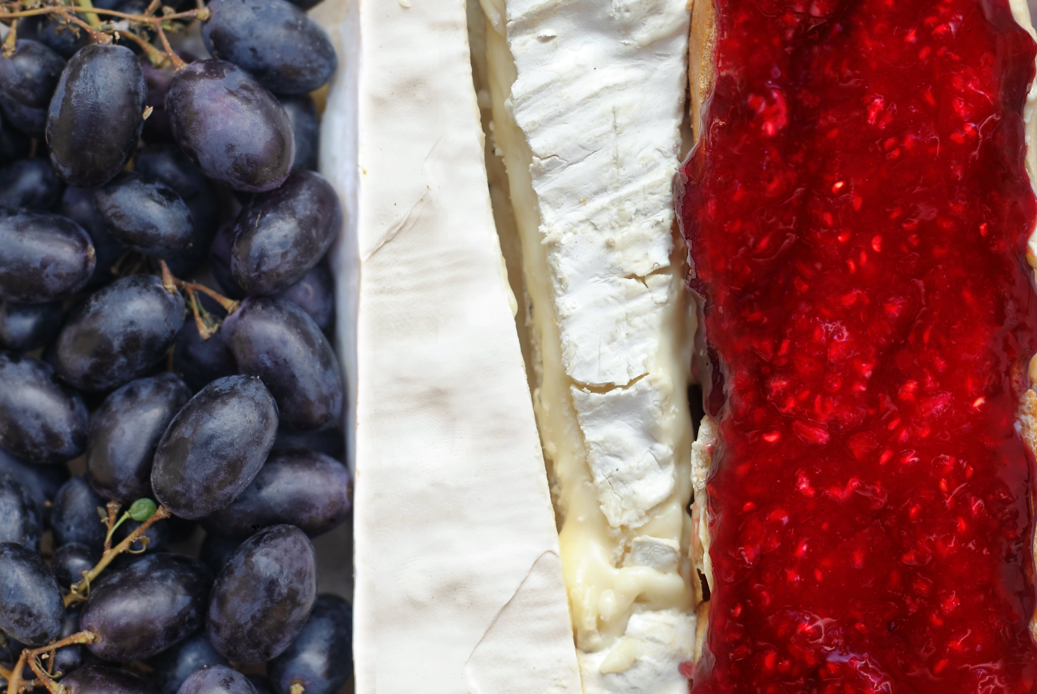 France's Flag made with grapes, Brie and Camembert cheeses and a baguette with jam (confiture)