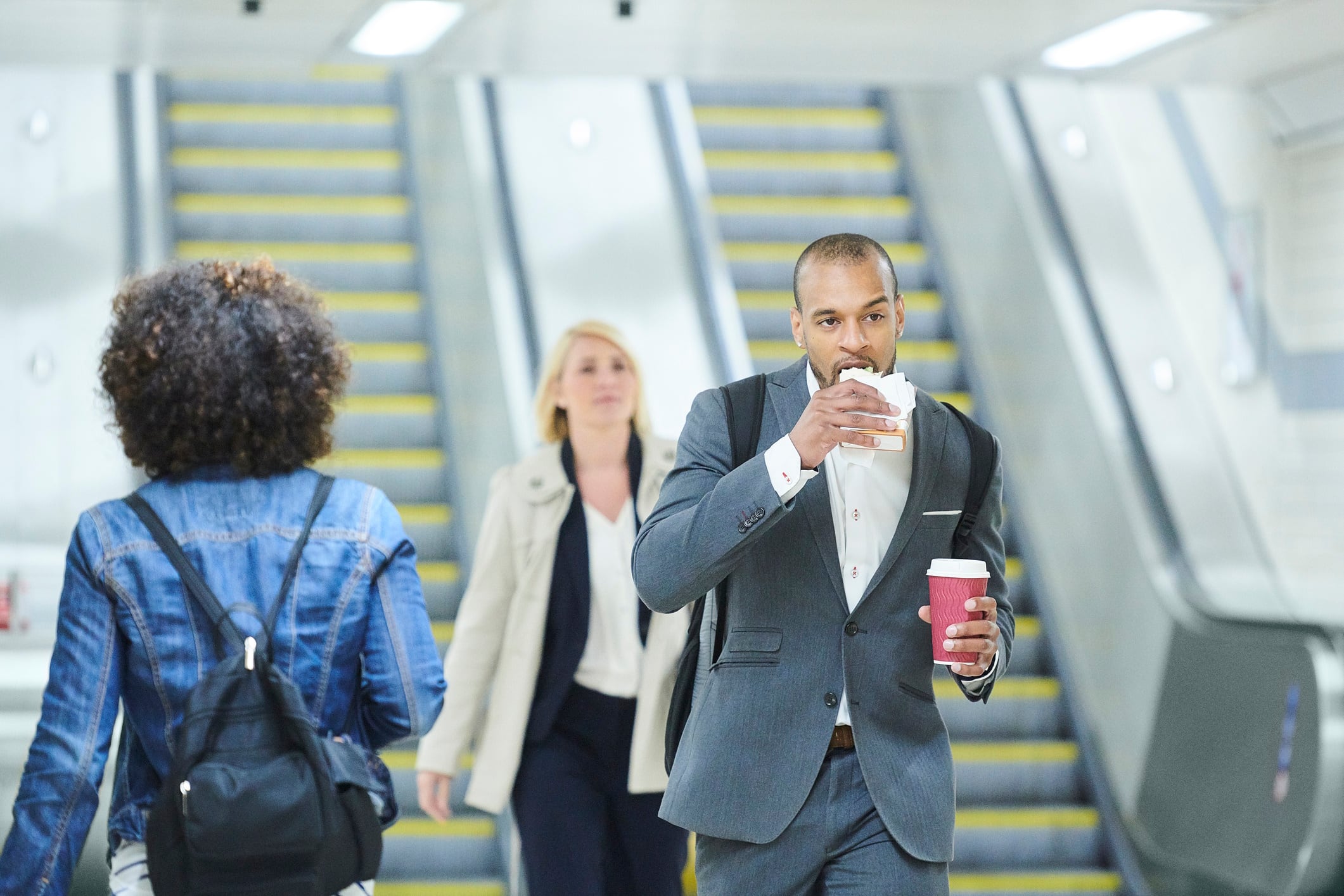 Businessman eating a sandwich on the go