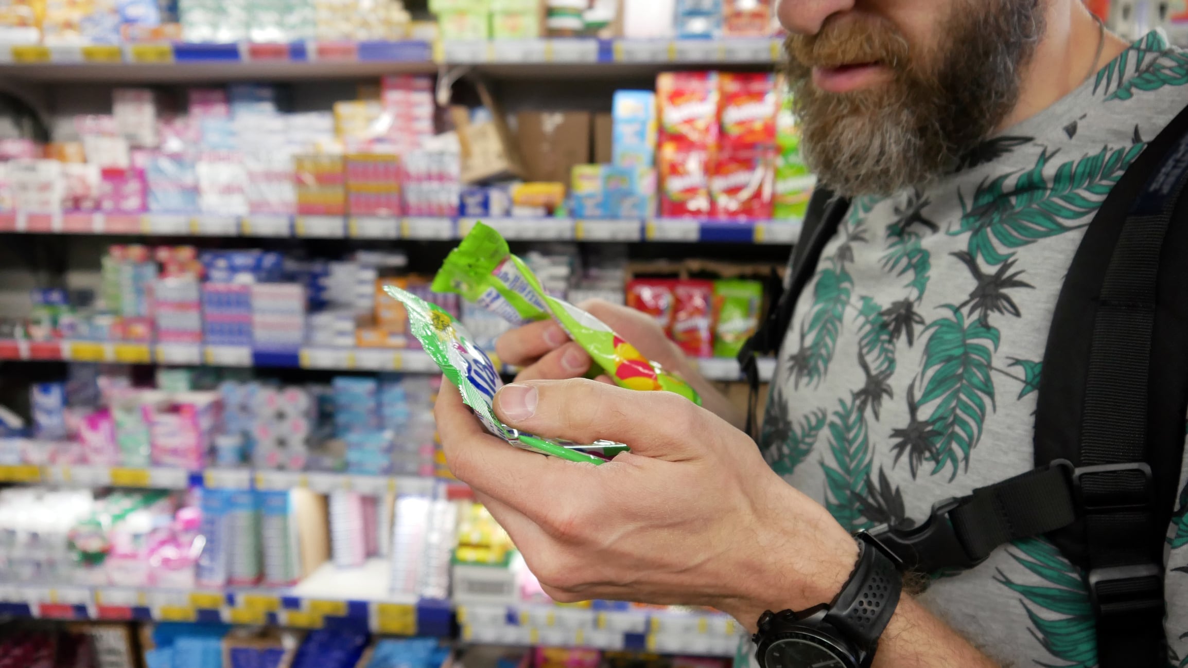 A male customer choosing sweets in a grocery store Stockah GettyImages