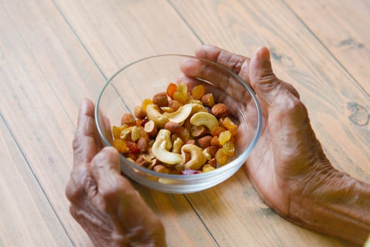 Old-woman-s-hands-with-a-bowl-of-nuts-healthy-snacking-Getty-towfiqu-ahamed.jpg