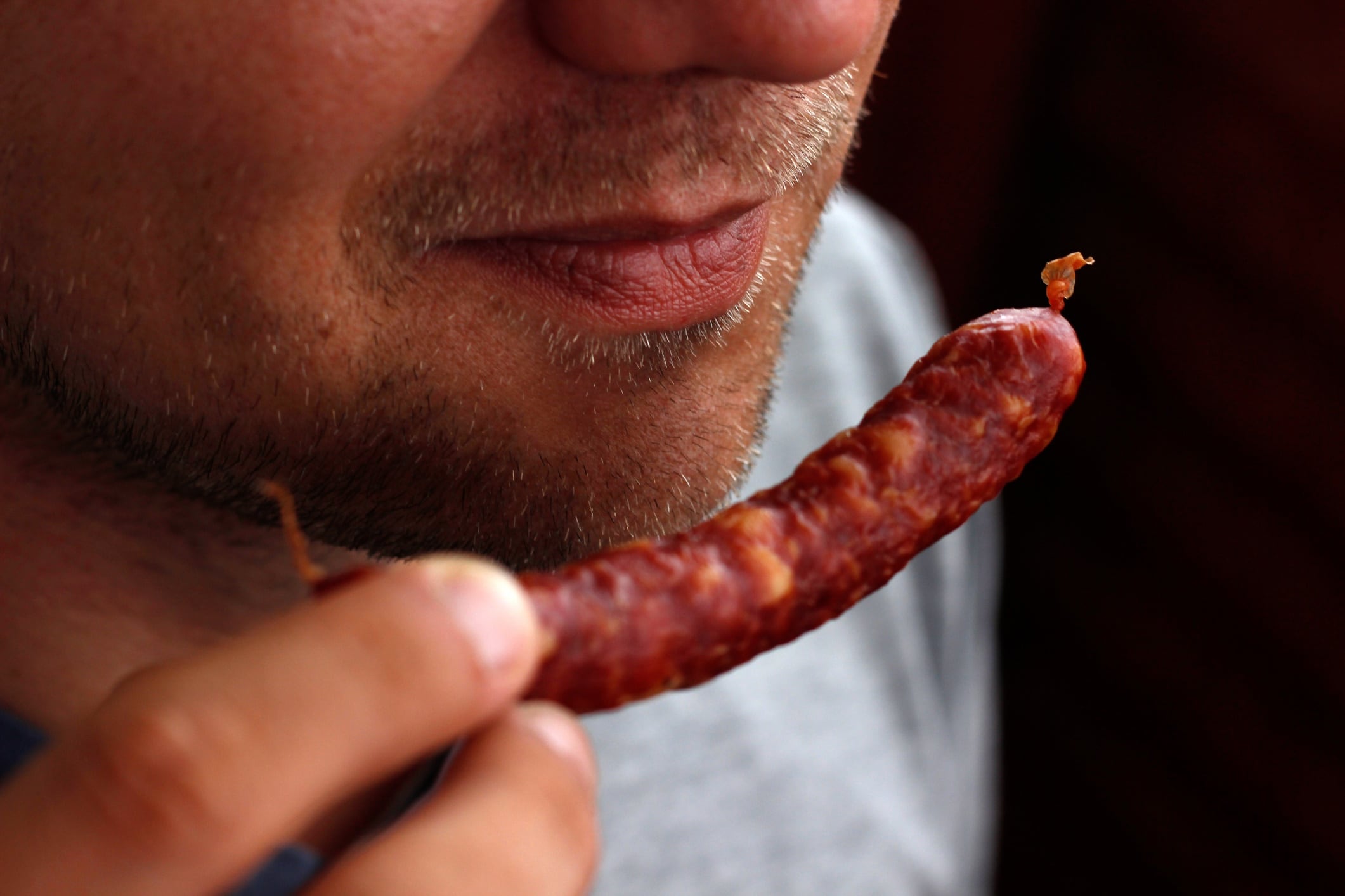 Close up of man with meat snack