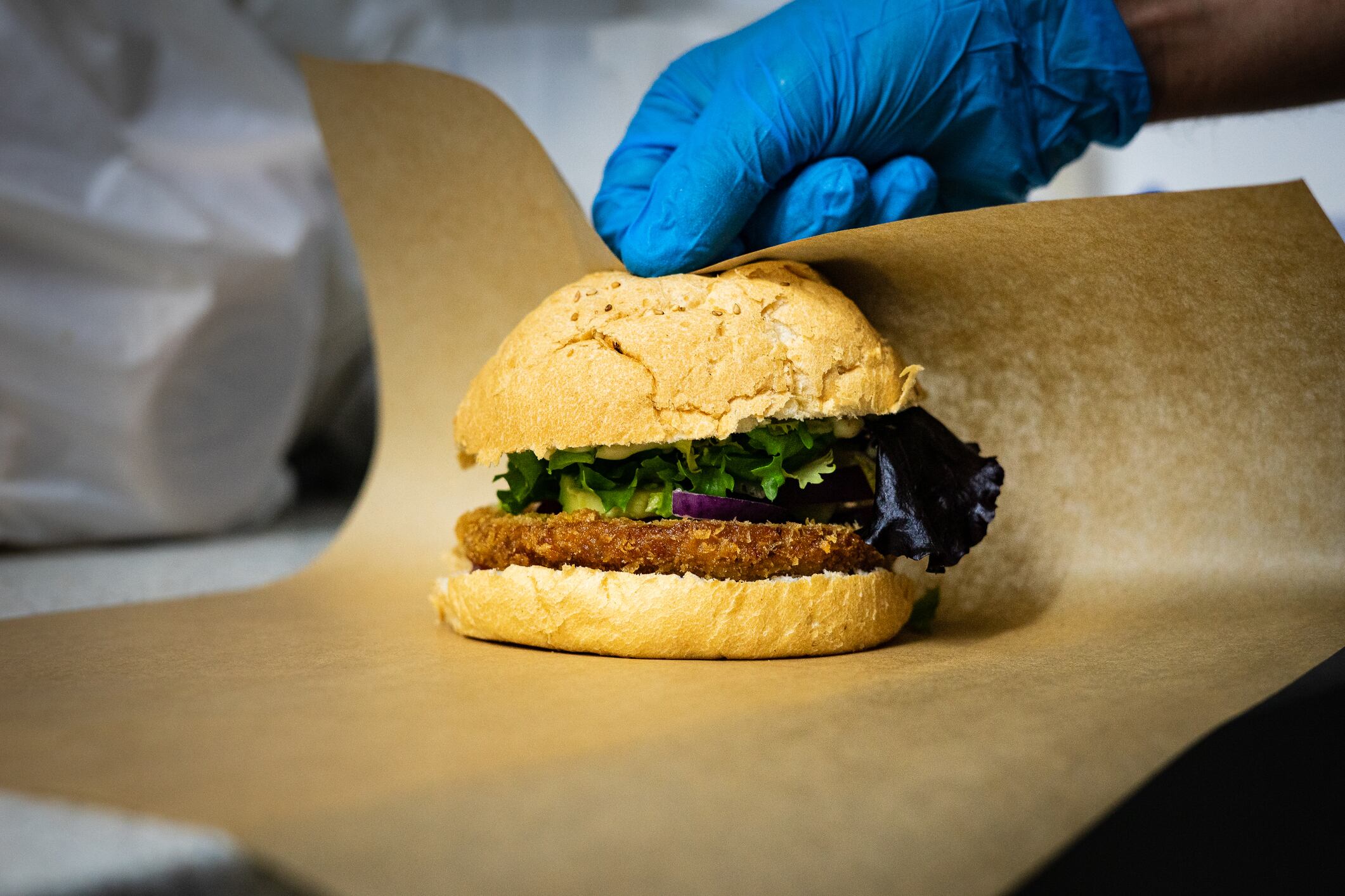 Cook wrapping vegan burger