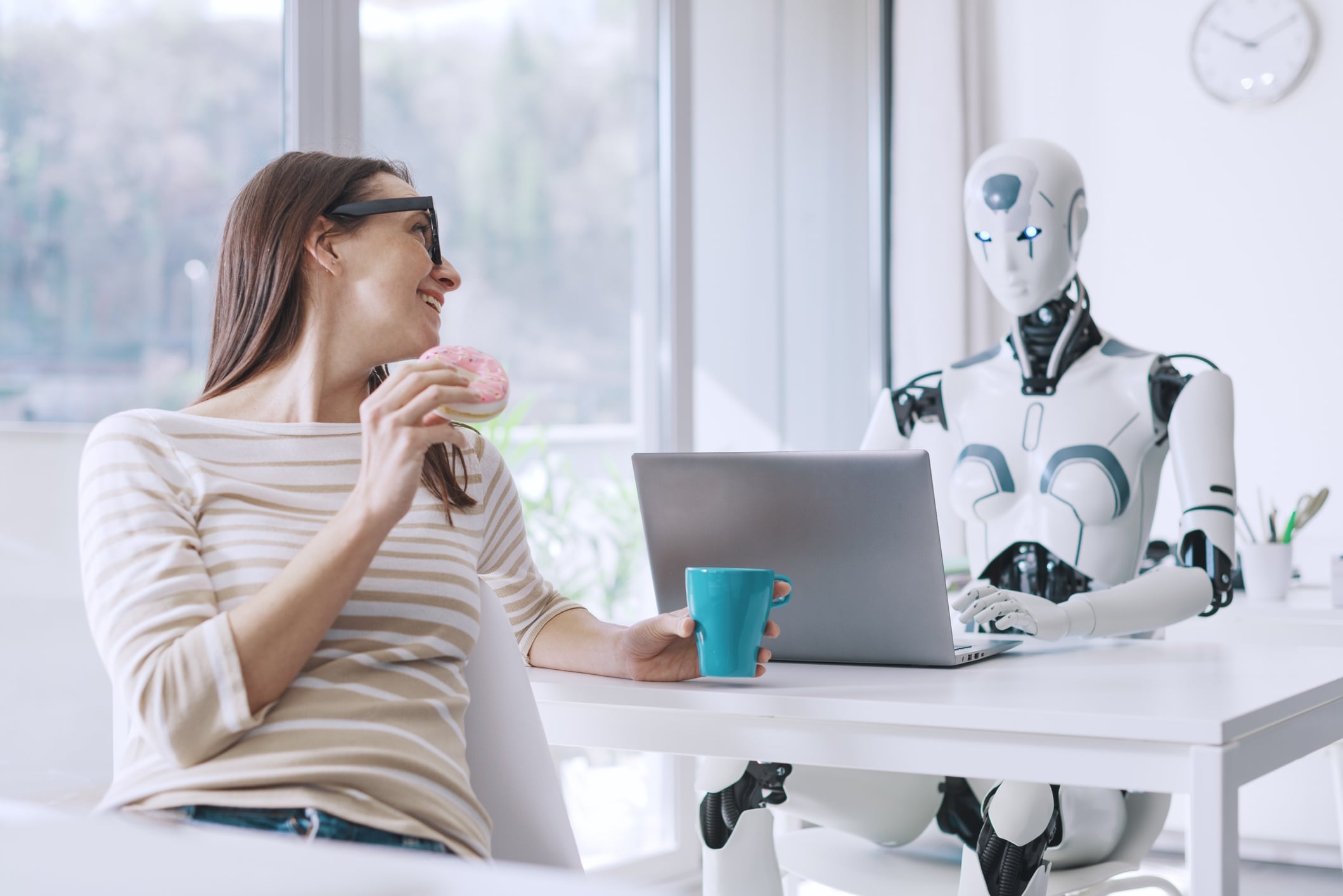 Office worker eating doughnut with AI robot