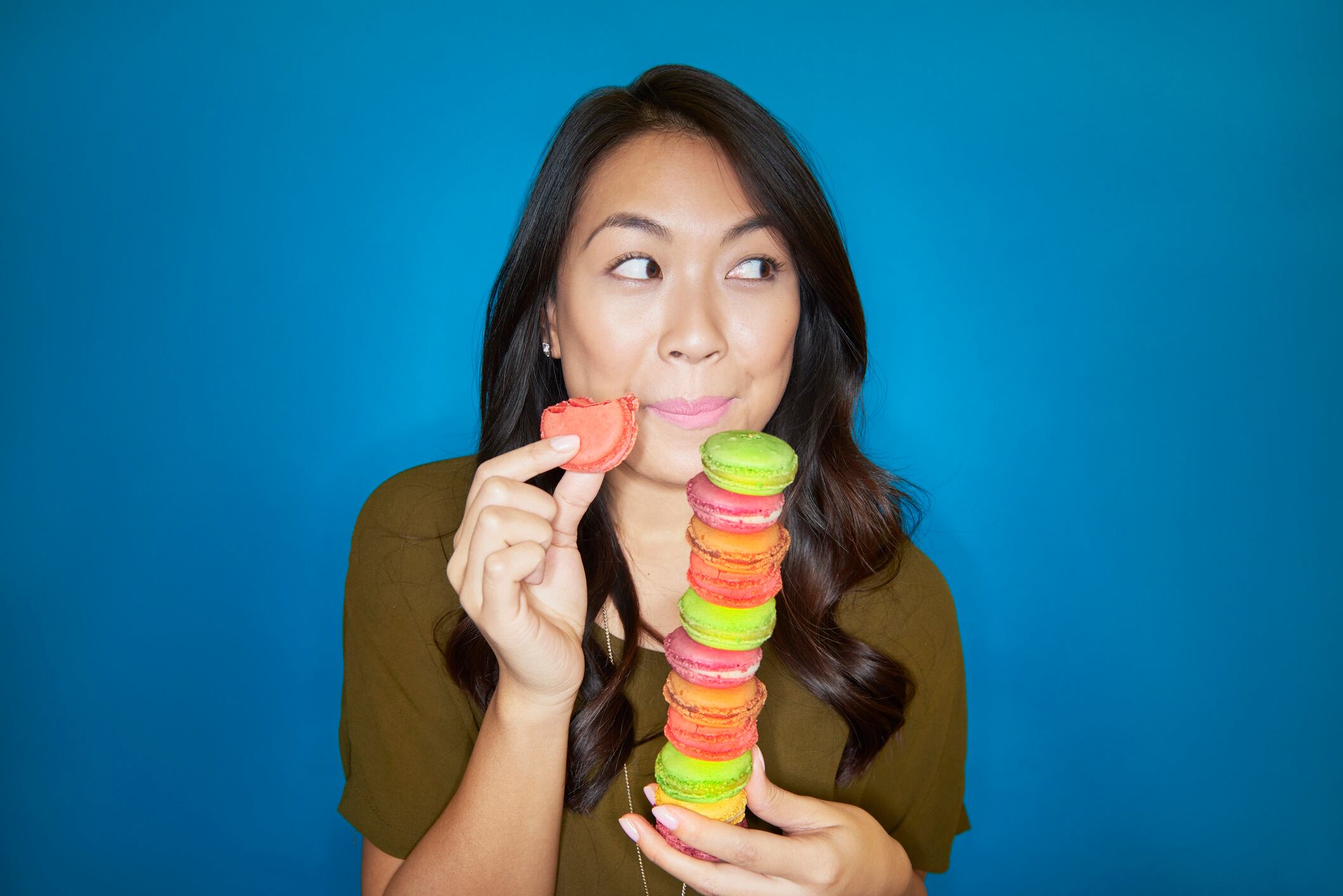 Woman eating colourful macarons