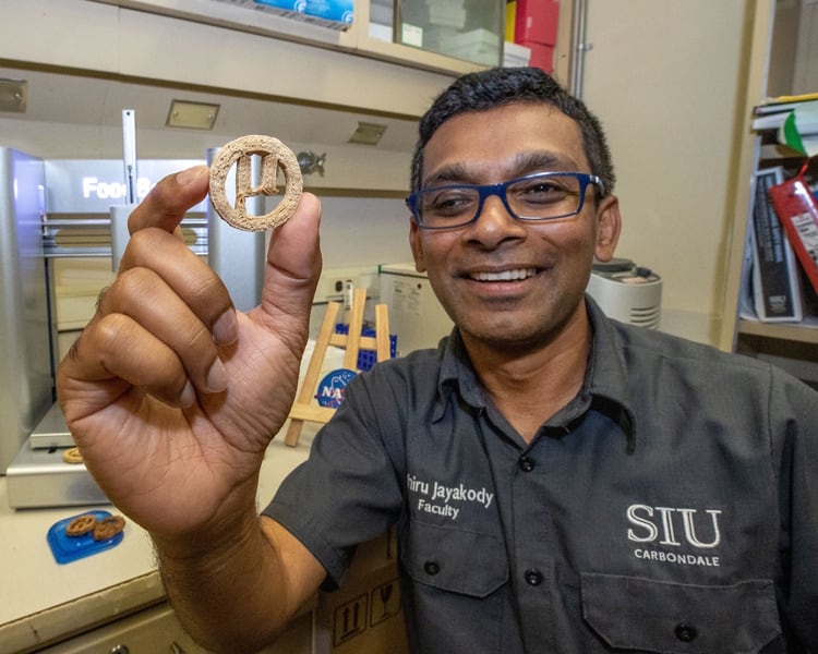 Dr Lahiru Jayakody with the µBites cookie. Image Rusty Bailey SIUC Media & Communication Resources.