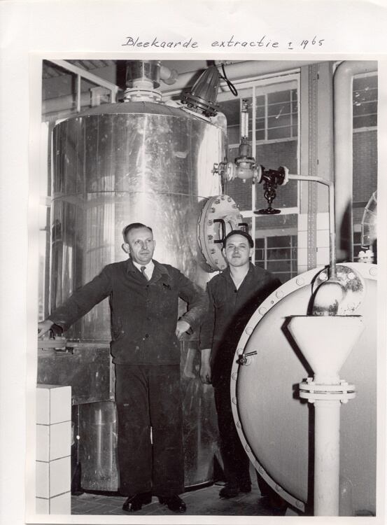 Employees stand beside extraction equipment at a Duyvis facility circa 1965. The company began as an oil mill in 1806 before evolving into one of the Netherlands' best-known nuts and savoury snacks brands.