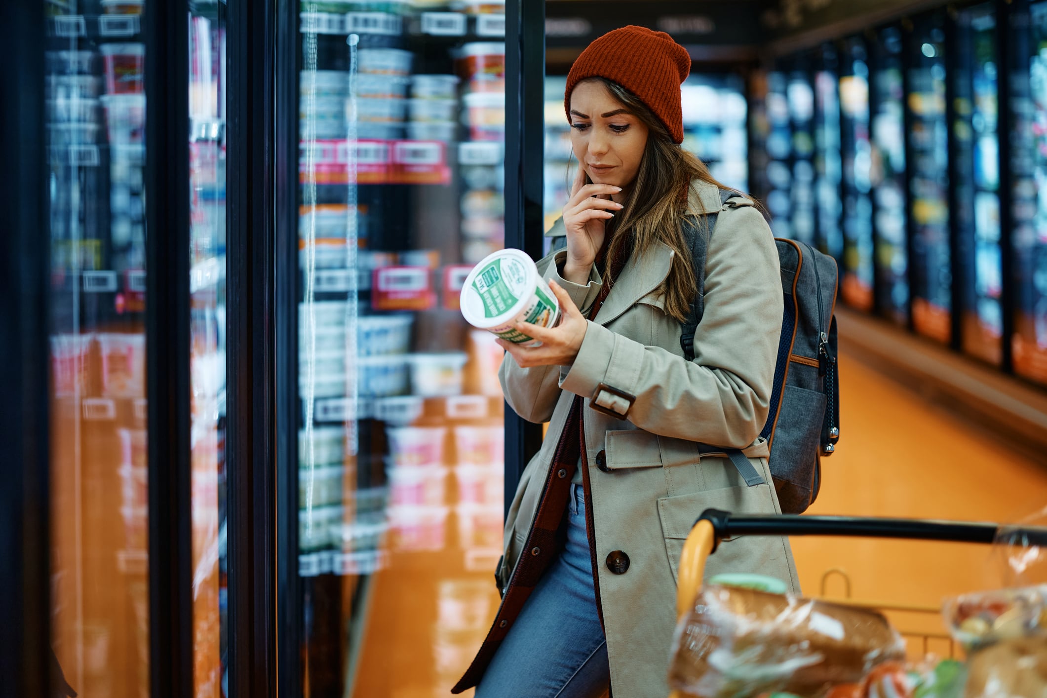 Young woman reading dairy yogurt label