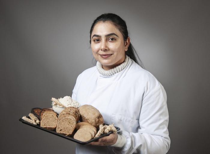 Dr Navneet Kaur with bread, toast and biscuits made from the CRISPR edited wheat.