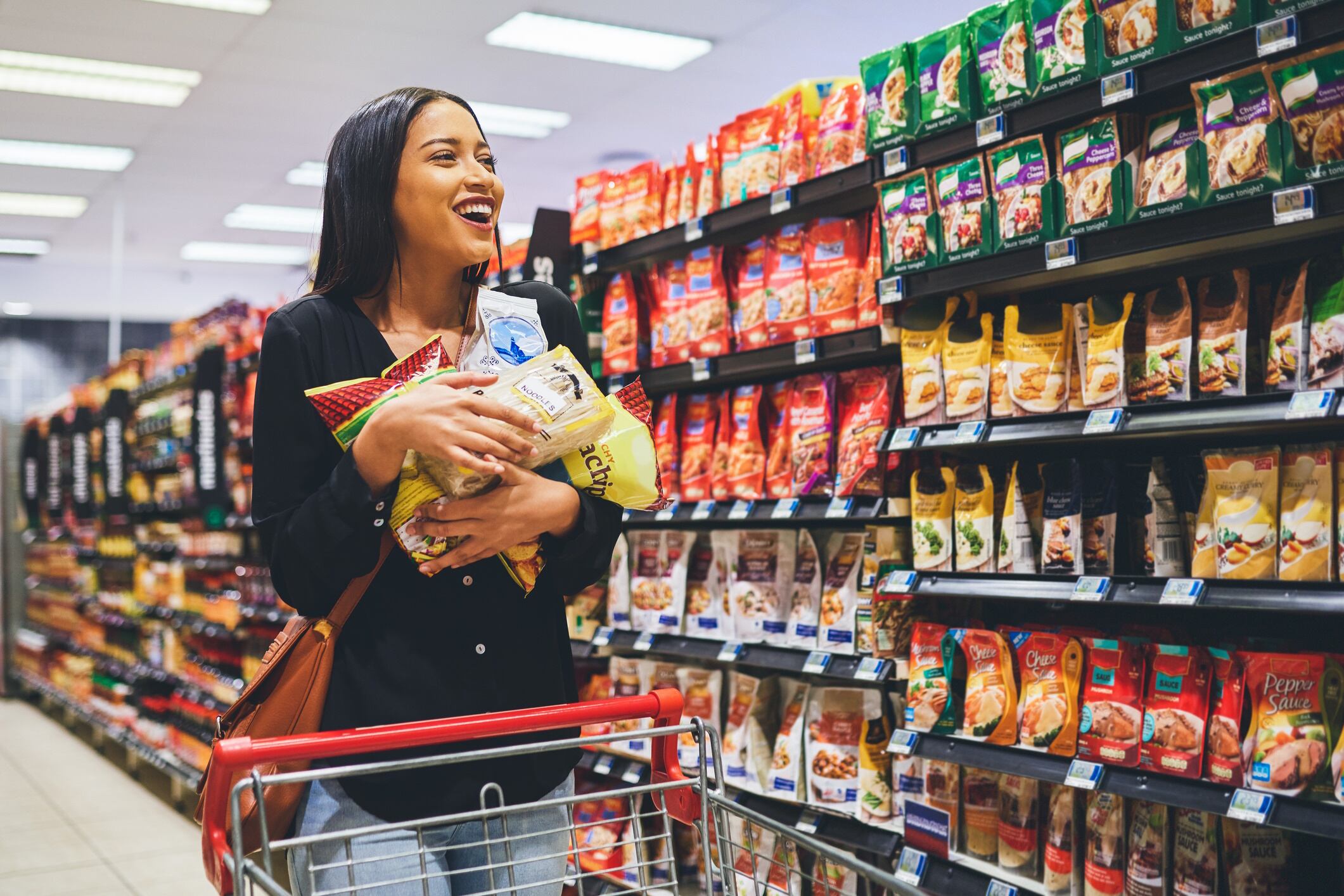 Woman holding bags of snacks
