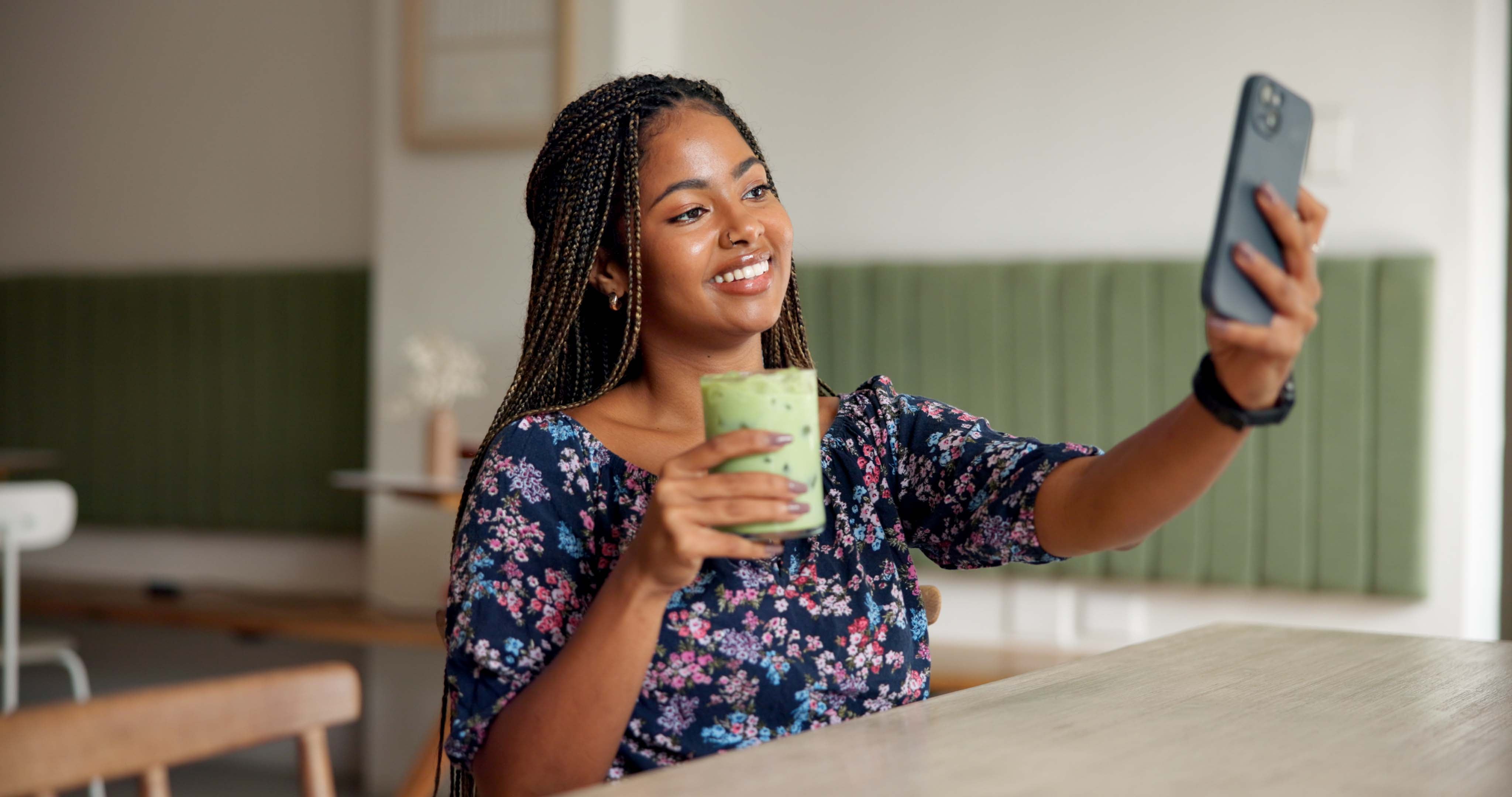 Happy, woman and selfie with green juice in cafe for social media post, wellness blog or online memory. Influencer, african girl or photography with organic smoothie in restaurant for profile picture