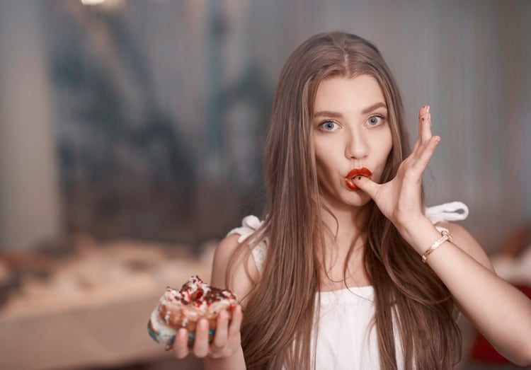 Woman-eating-a-doughnut-stock_colors.jpg