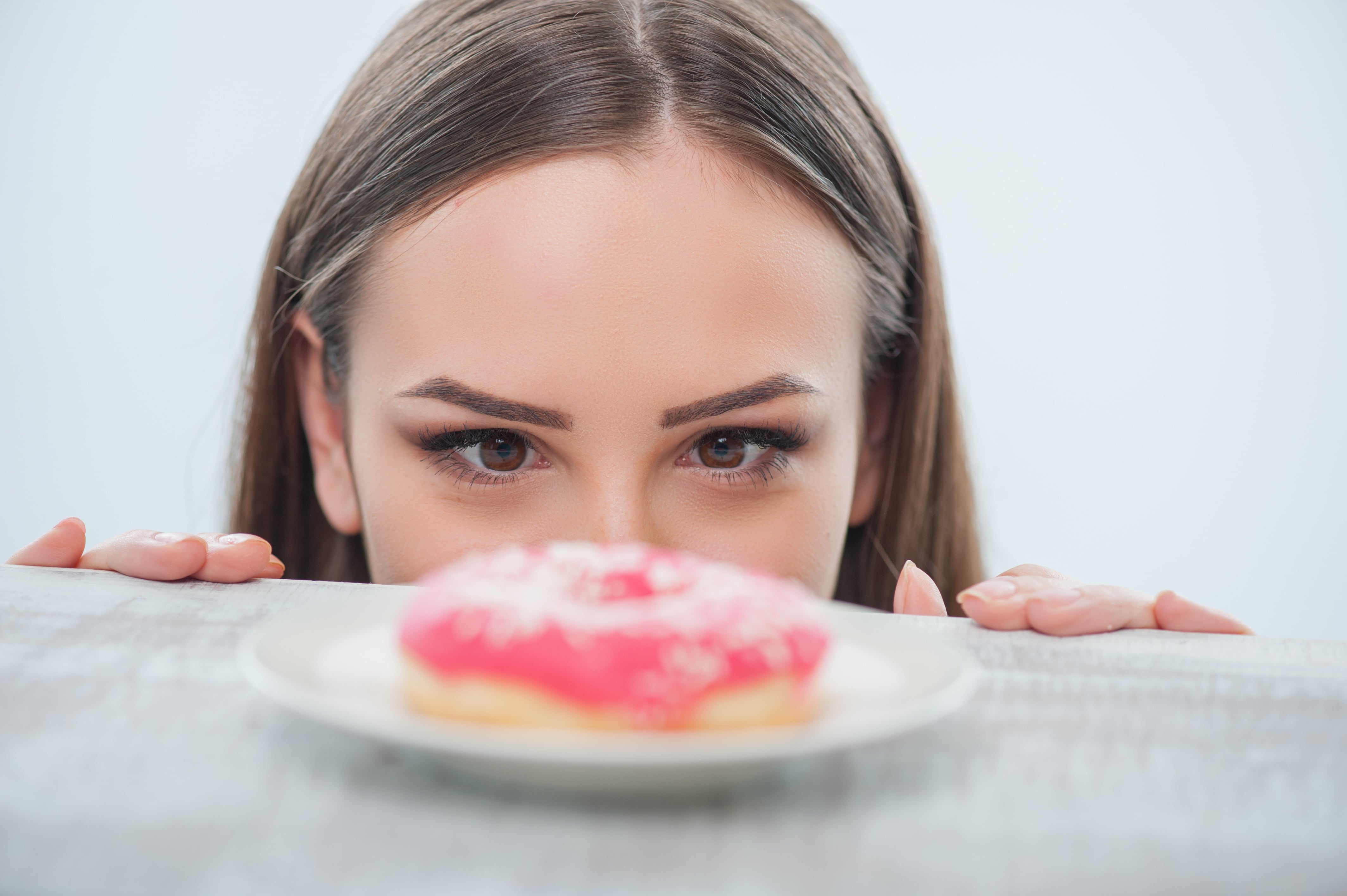 Woman eyeing a doughnut