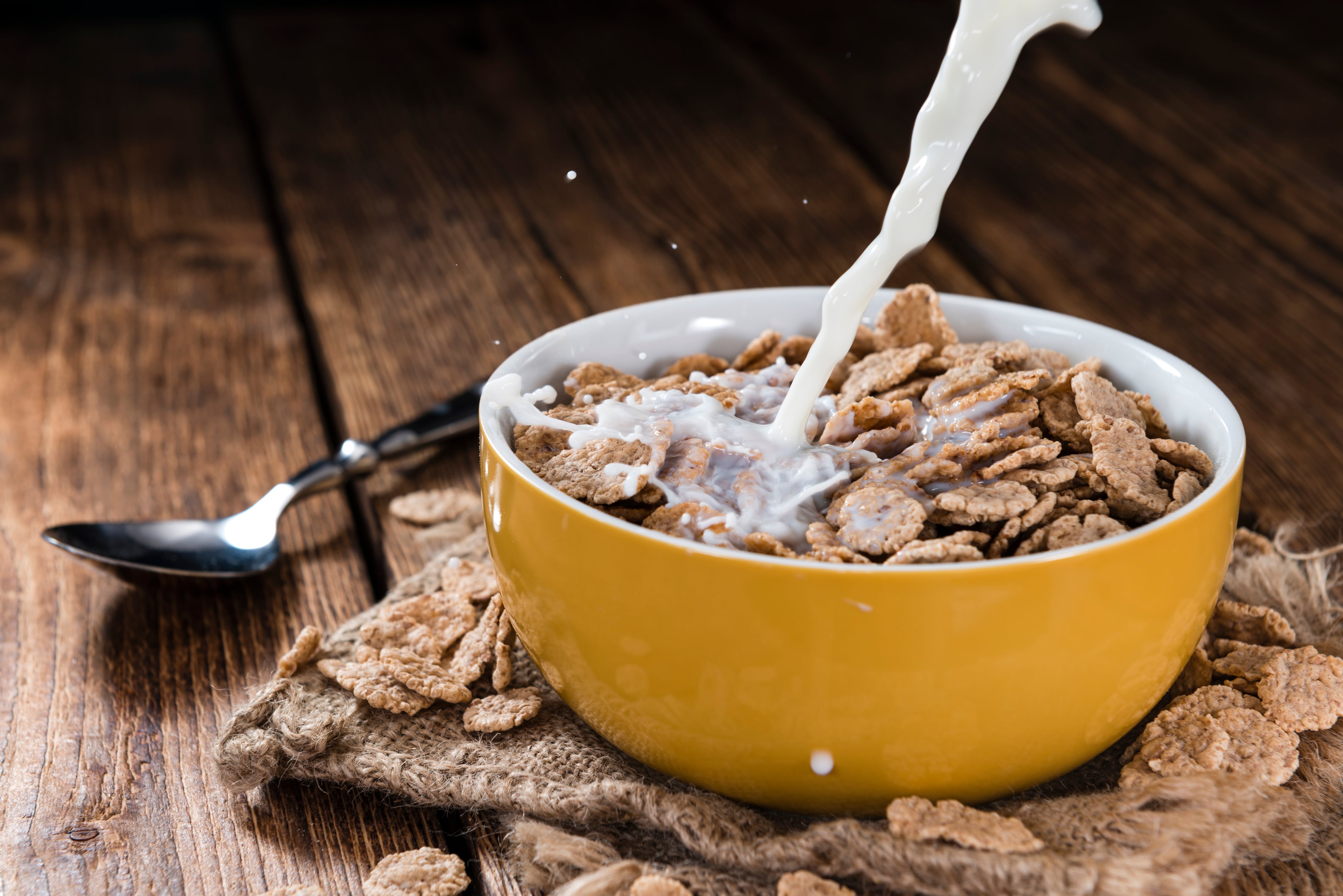 Pouring Milk in a bowl with wholemeal Cornflakes