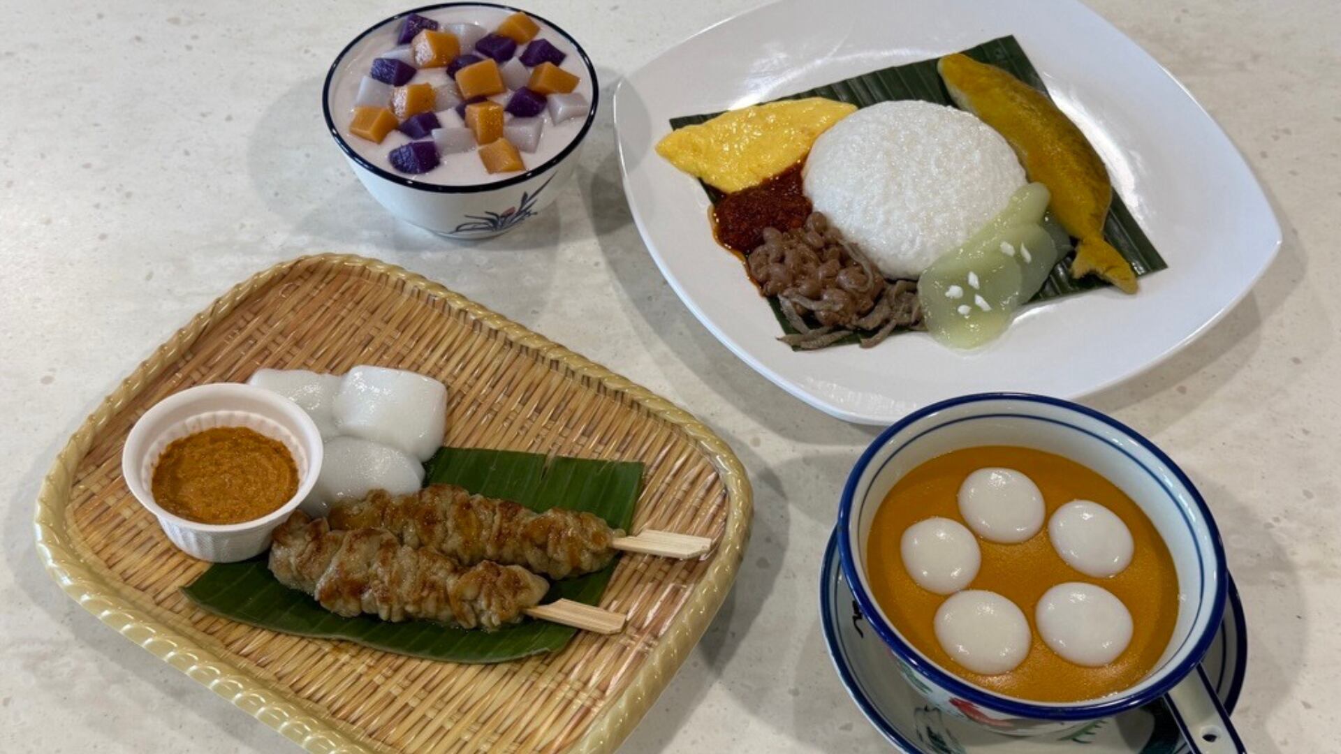 Foods modified by MAKANsoft texturant (clockwise from top left): Burbur chacha, nasi lemak, curry fishballs, and satay. These dishes were blended, reconstructed and moulded using MAKANsoft to achieve safe textures.