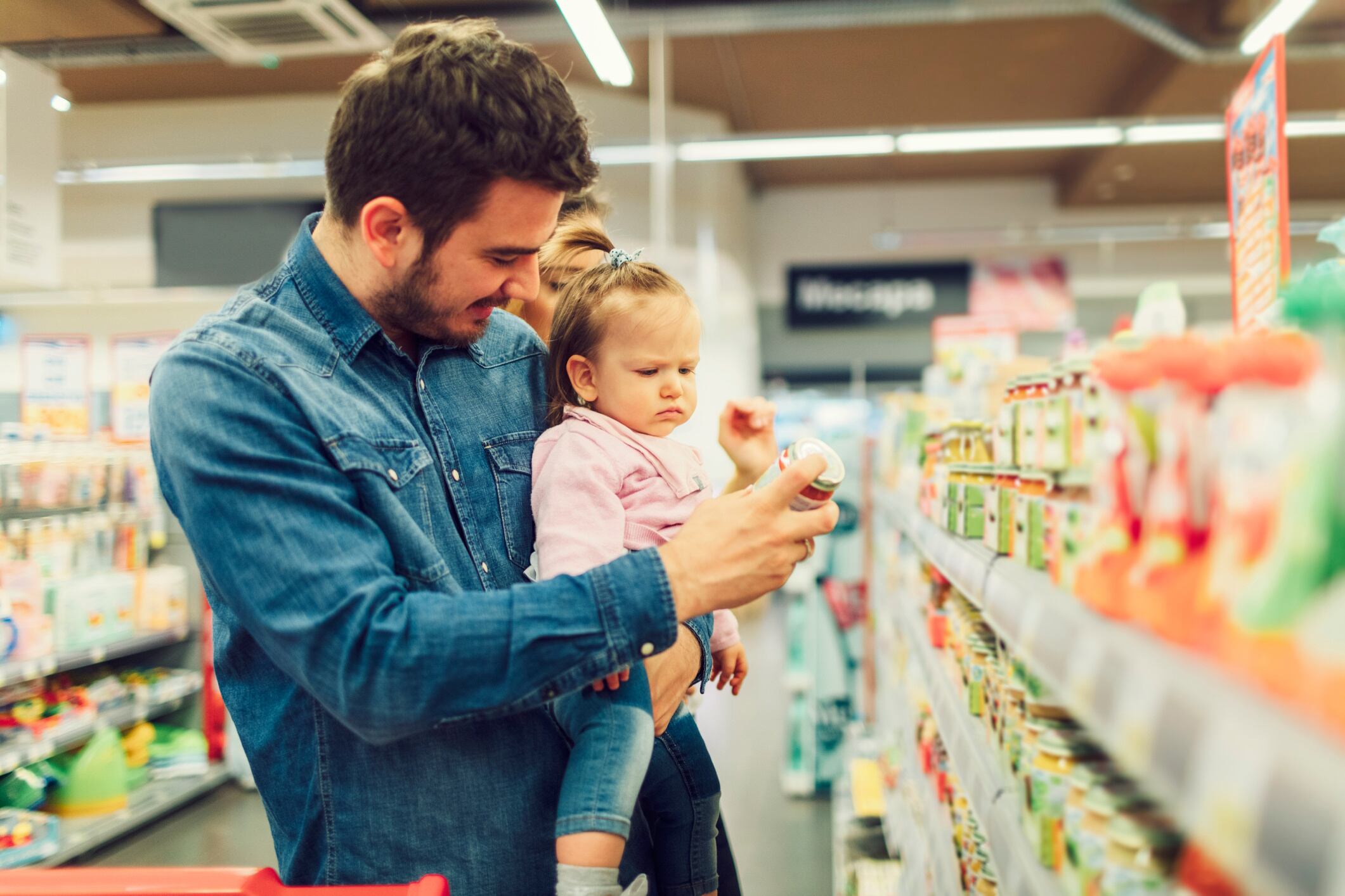 Father and daughter buying baby food