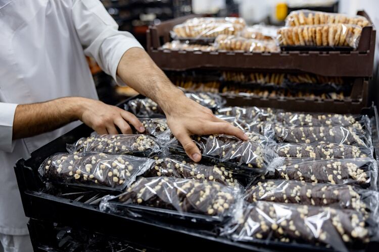 Worker-with-packaged-bread-in-bread-baskets-GettyImages-1833456837.jpg