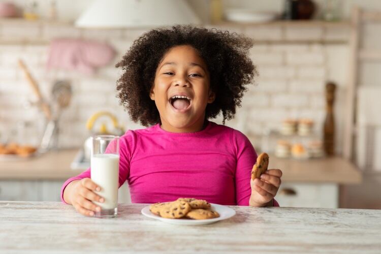 Young-girl-smiling-with-a-biscuit-Cargill.jpg