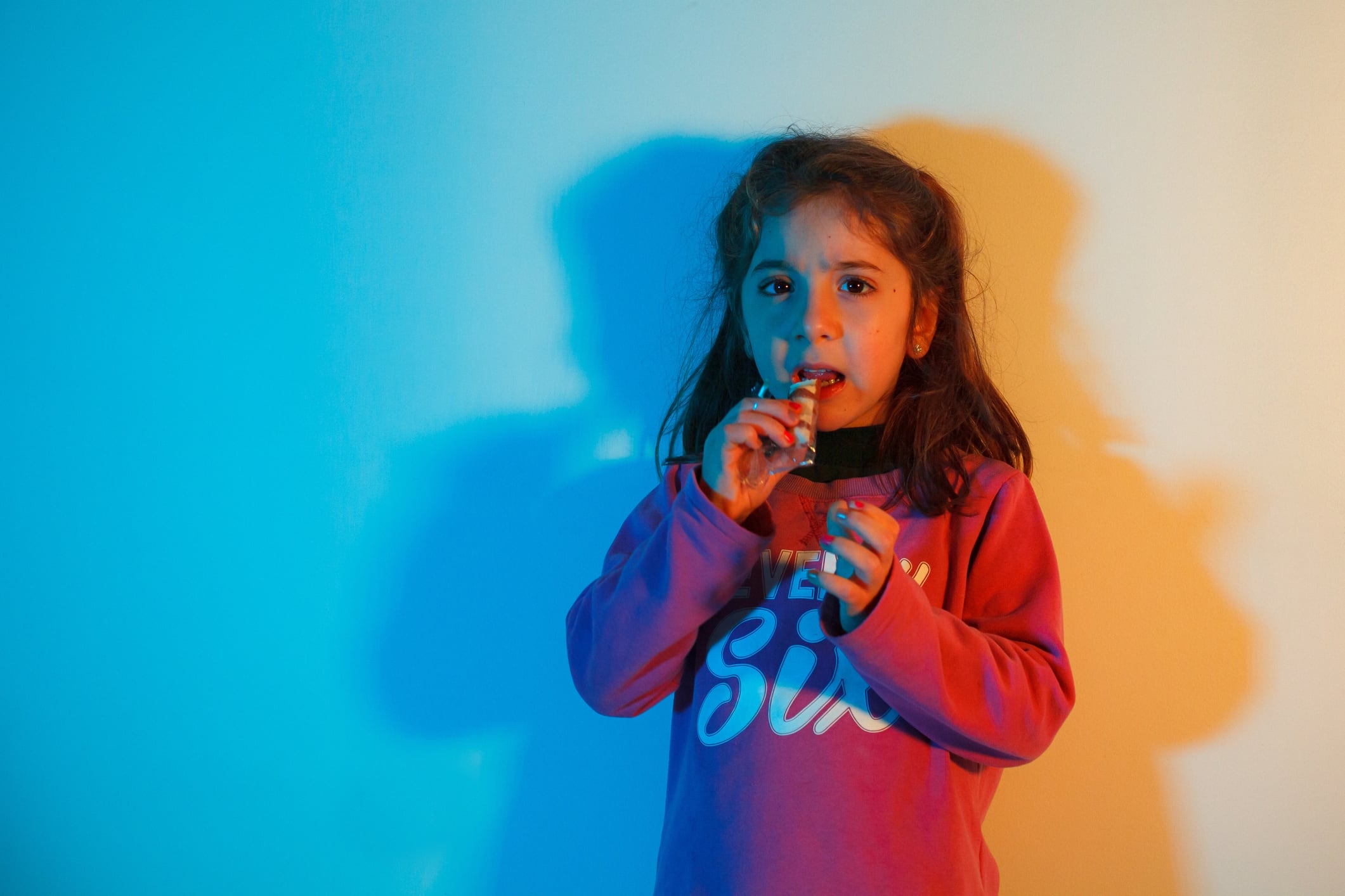 Portrait of a child eating a snack high protein bar