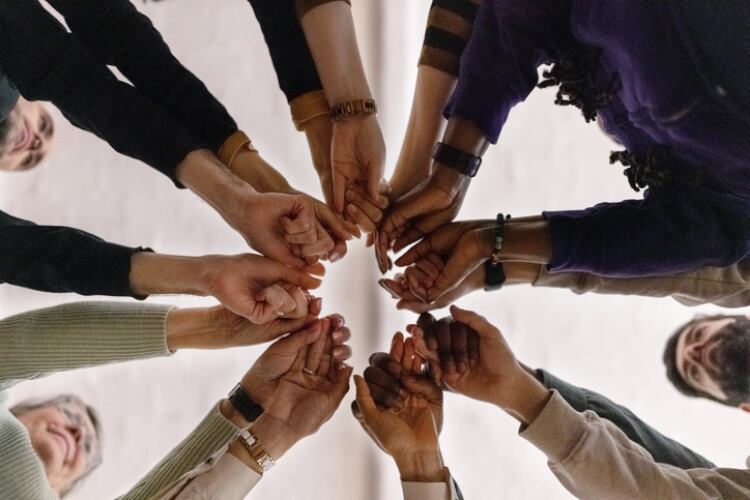 Advocacy groups with hands together