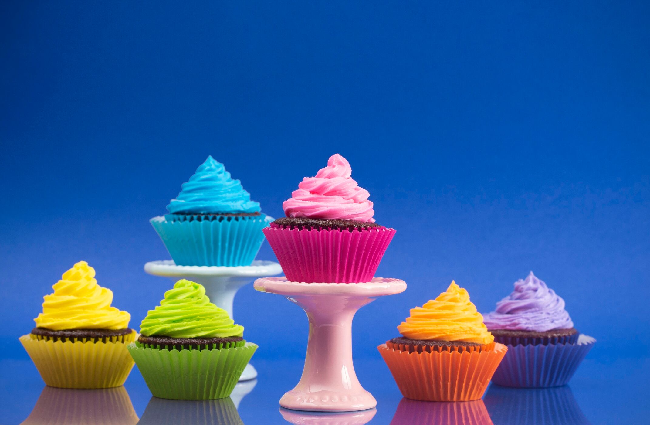 Rainbow Colored Frosted Chocolate Cupcakes set for a Party