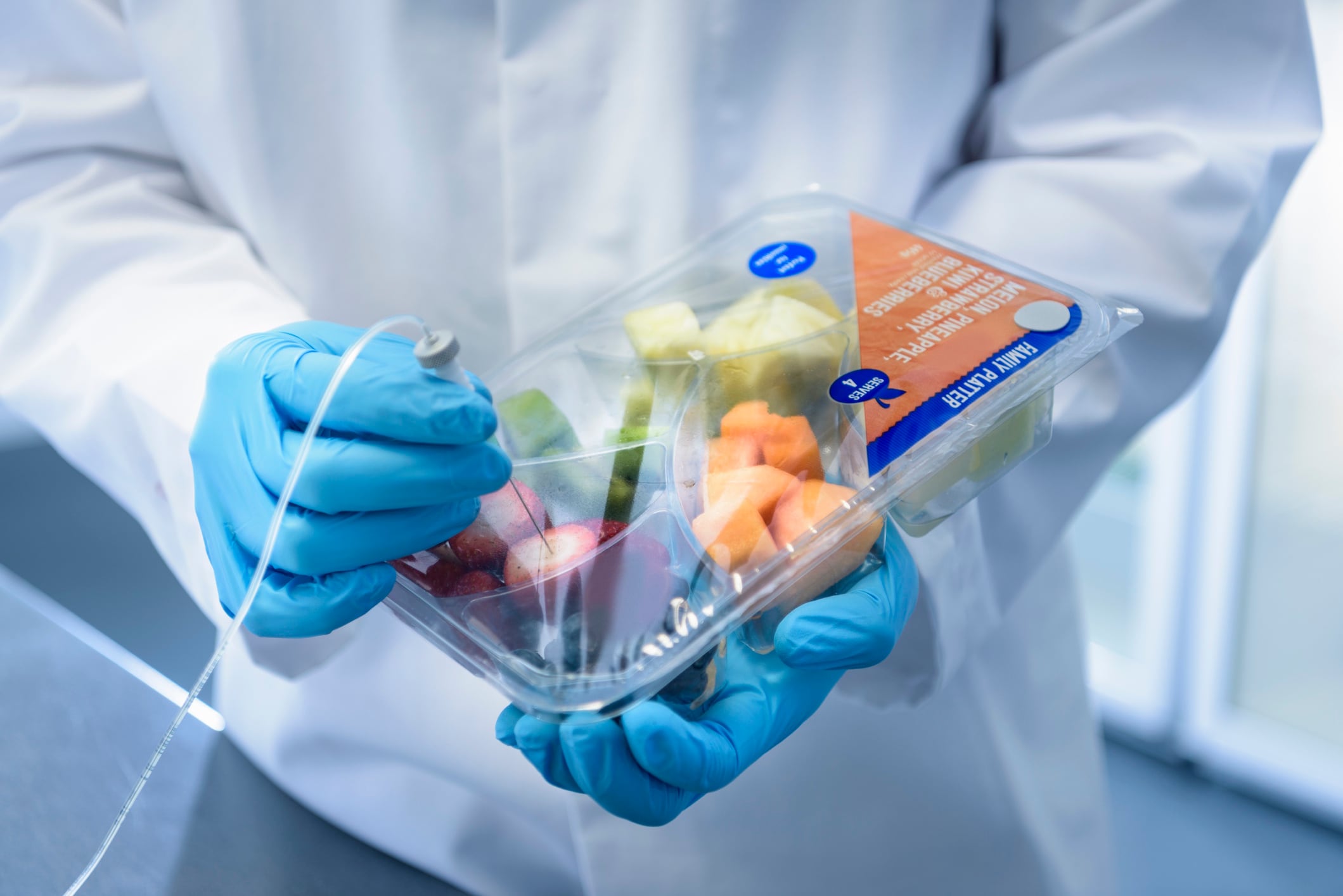 Close up of scientist inspecting food for freshness in laboratory in food packaging printing factory Monty Rakusen GettyImages