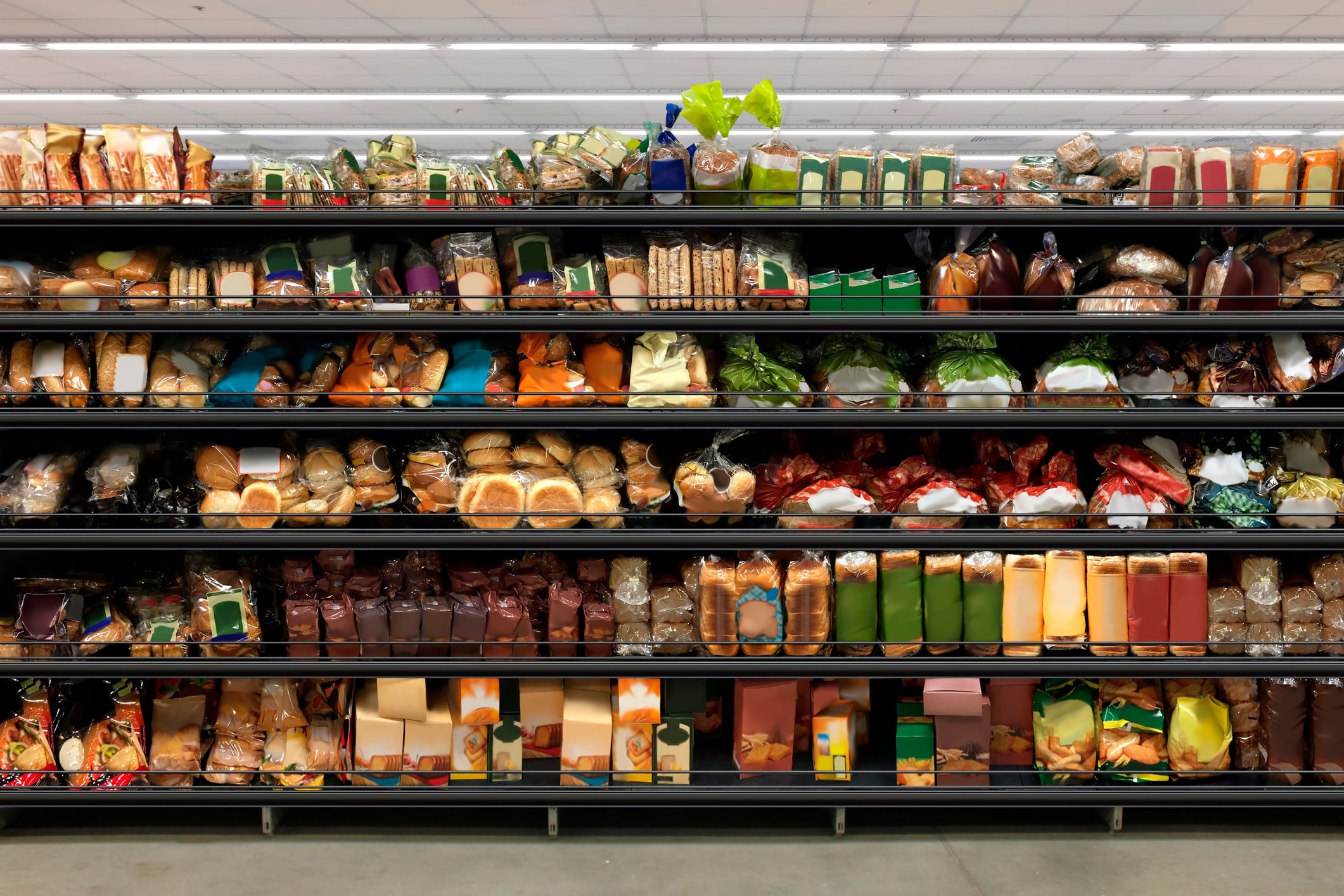 Bread stacked on supermarket shelves Hitra GettyImages
