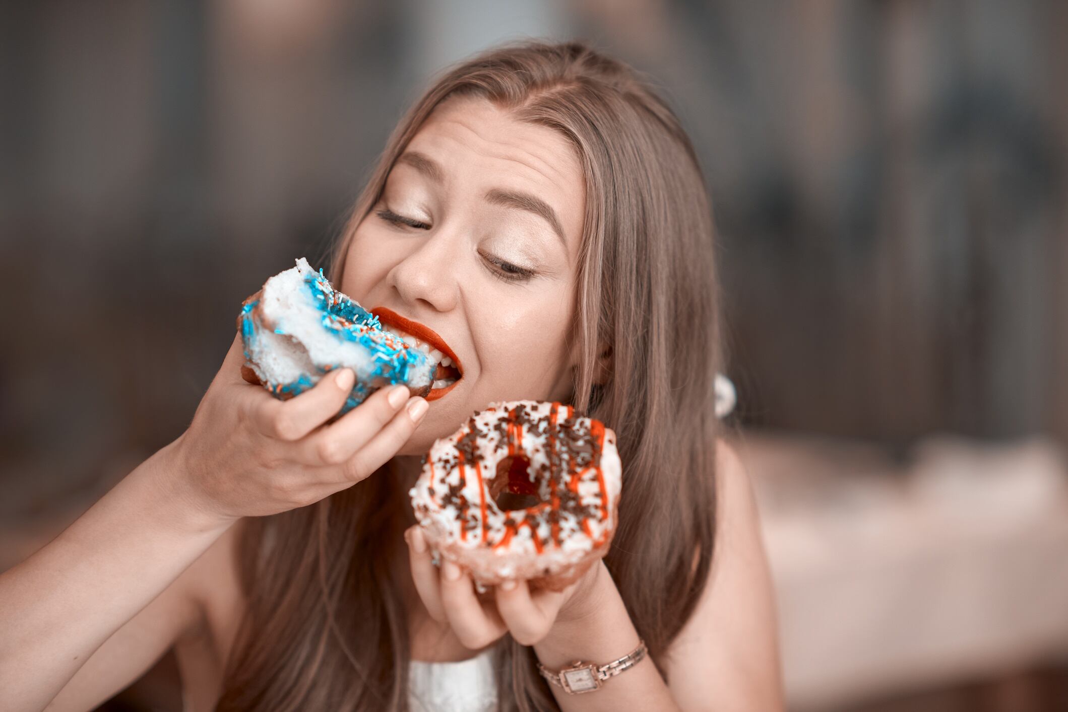 Woman eating doughnuts