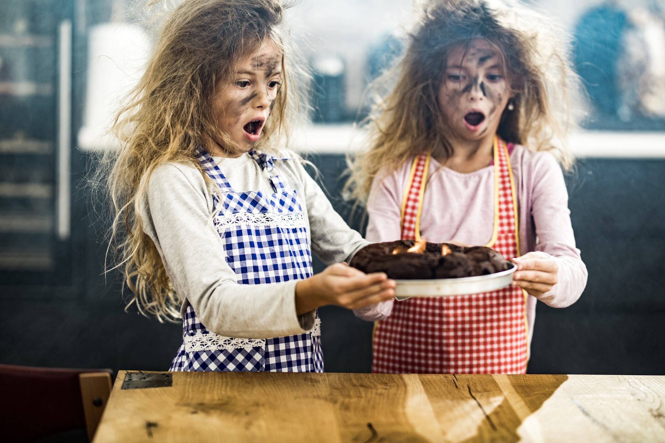 Twins with a burnt cake