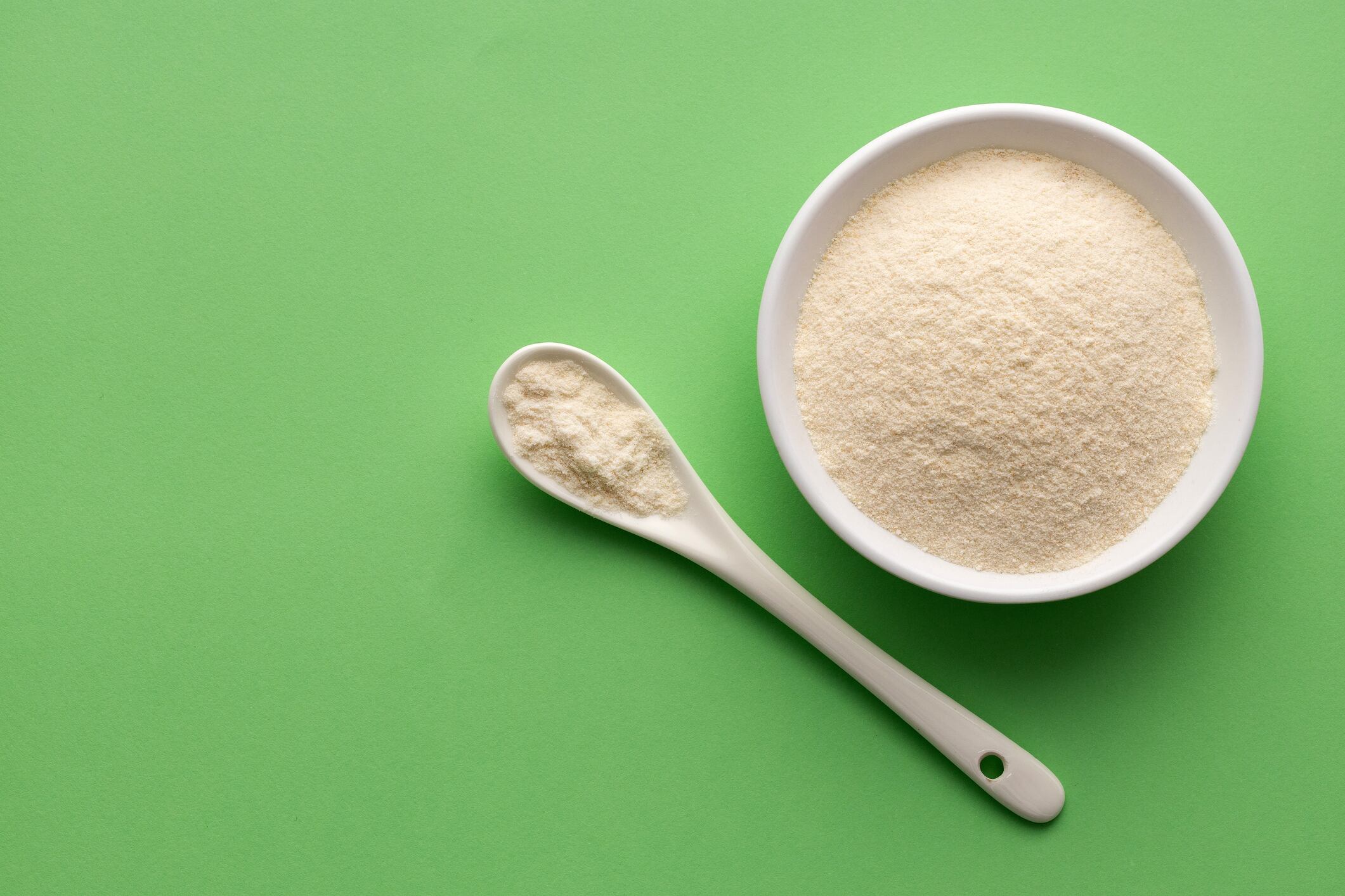 Organic gelatin powder also called hydrolyzed collagen - White powder in the bowl and spoon