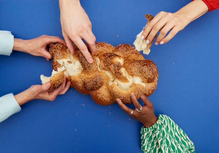 Hands grabbing for bread