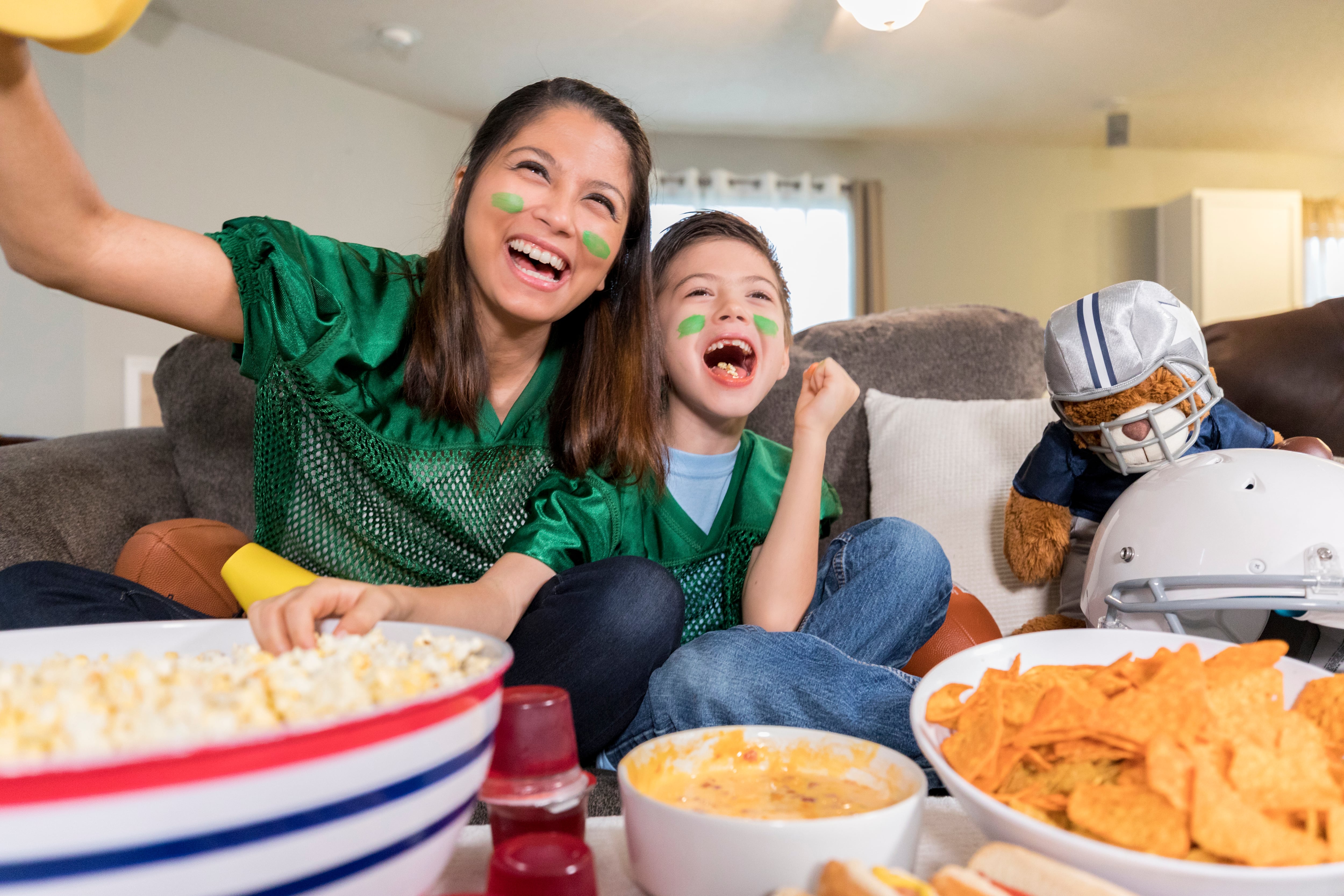 Mother and son enjoy Super Bowl and snacks