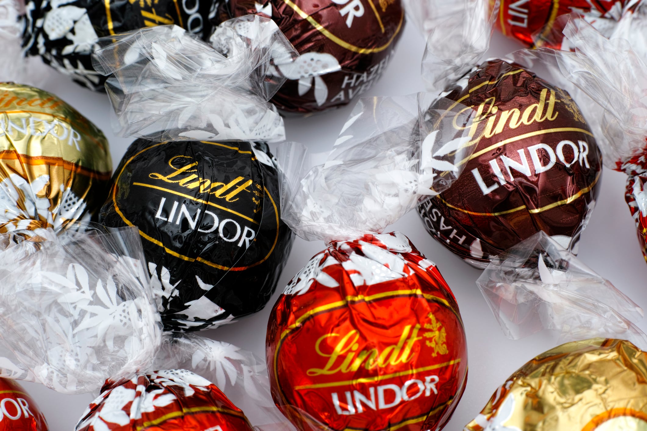 Tambov, Russian Federation - March 08, 2015: Lindt Lindor chocolate truffles on white background. Lindor assorted balls: the Lindt milk, dark and white chocolate candies. Studio shot.