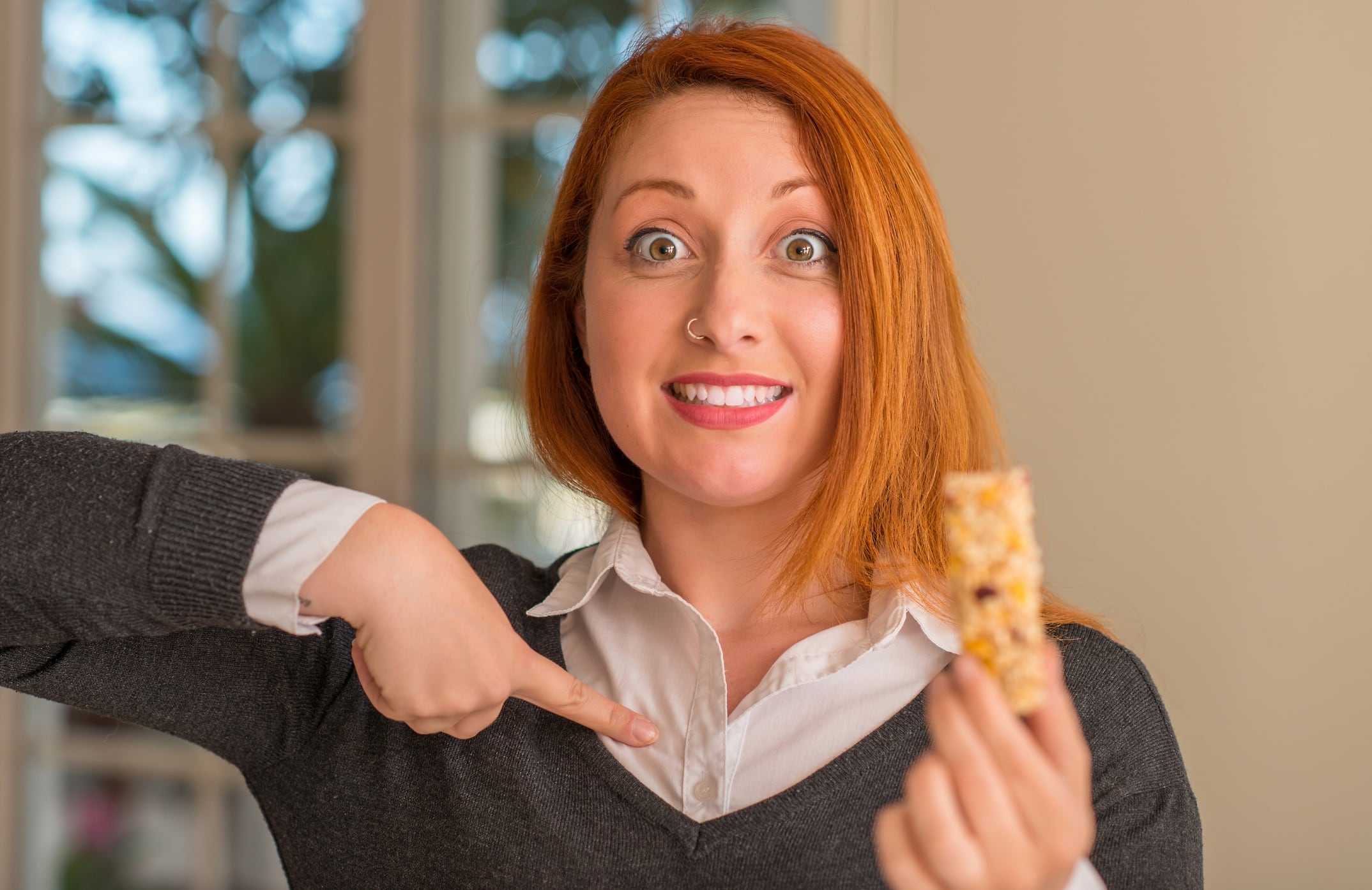 Red haired lady about to eat snack bar