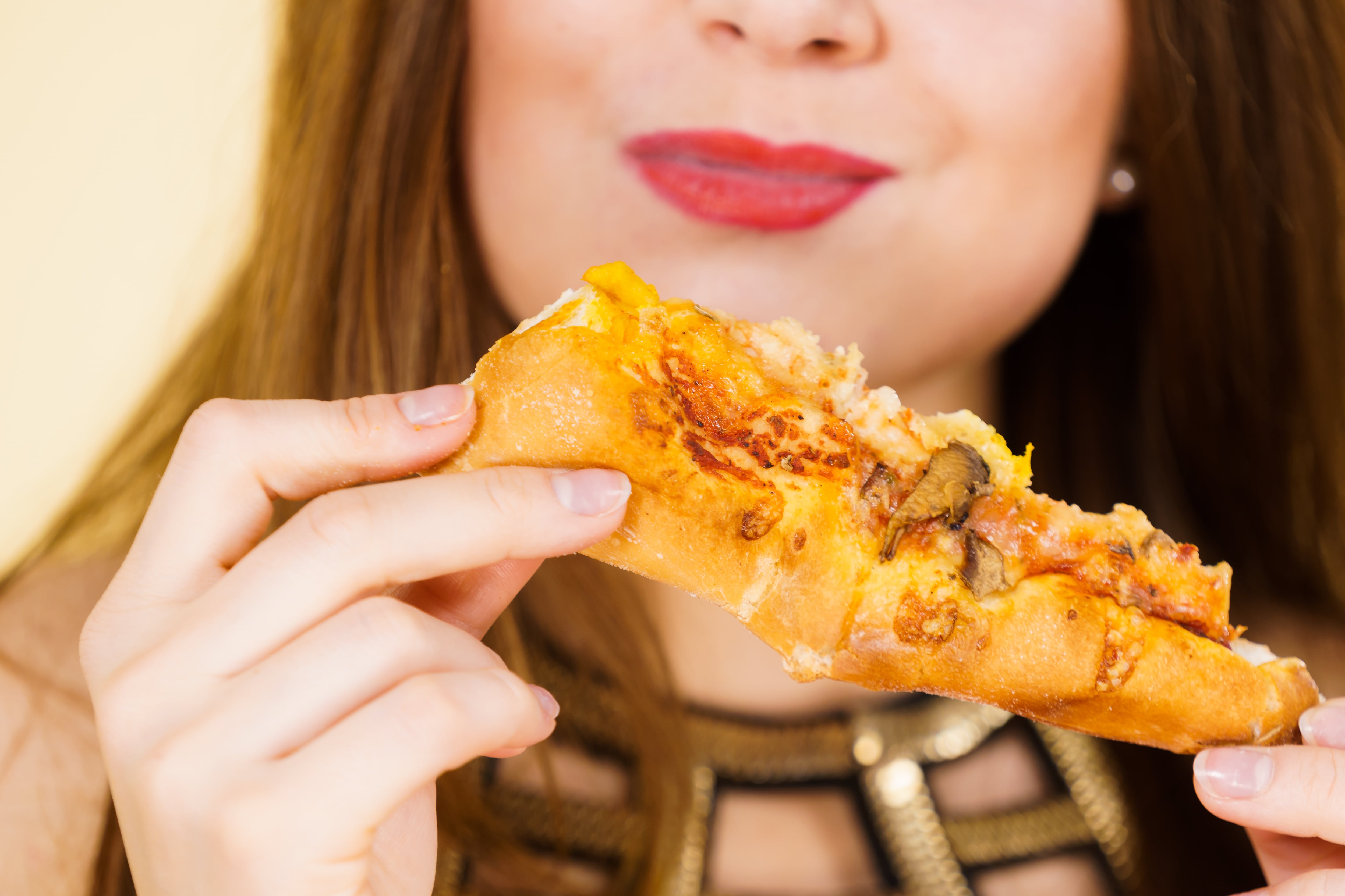 Woman eating pizza