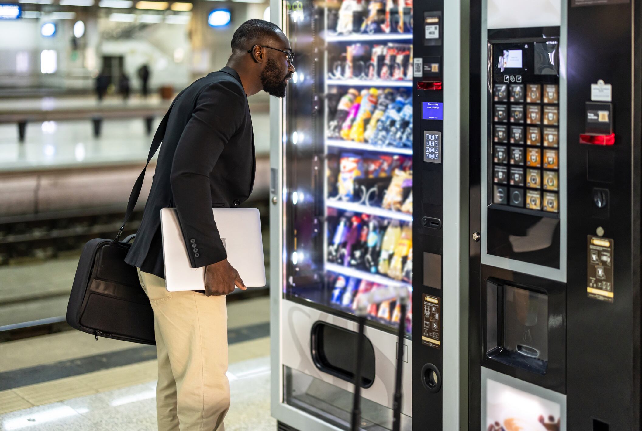 Man looking at snacks in a vending machine