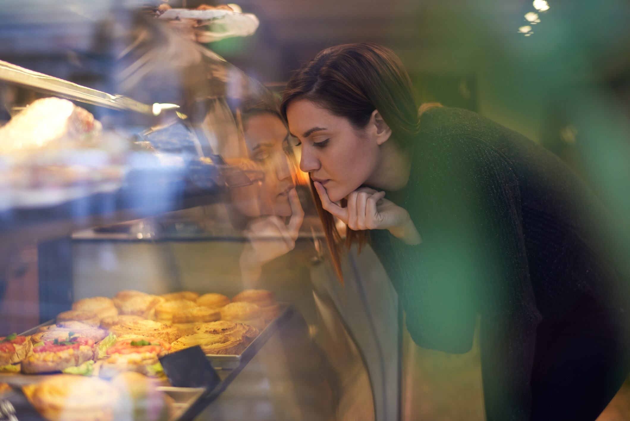 Female customer inside the bakery choosing products
