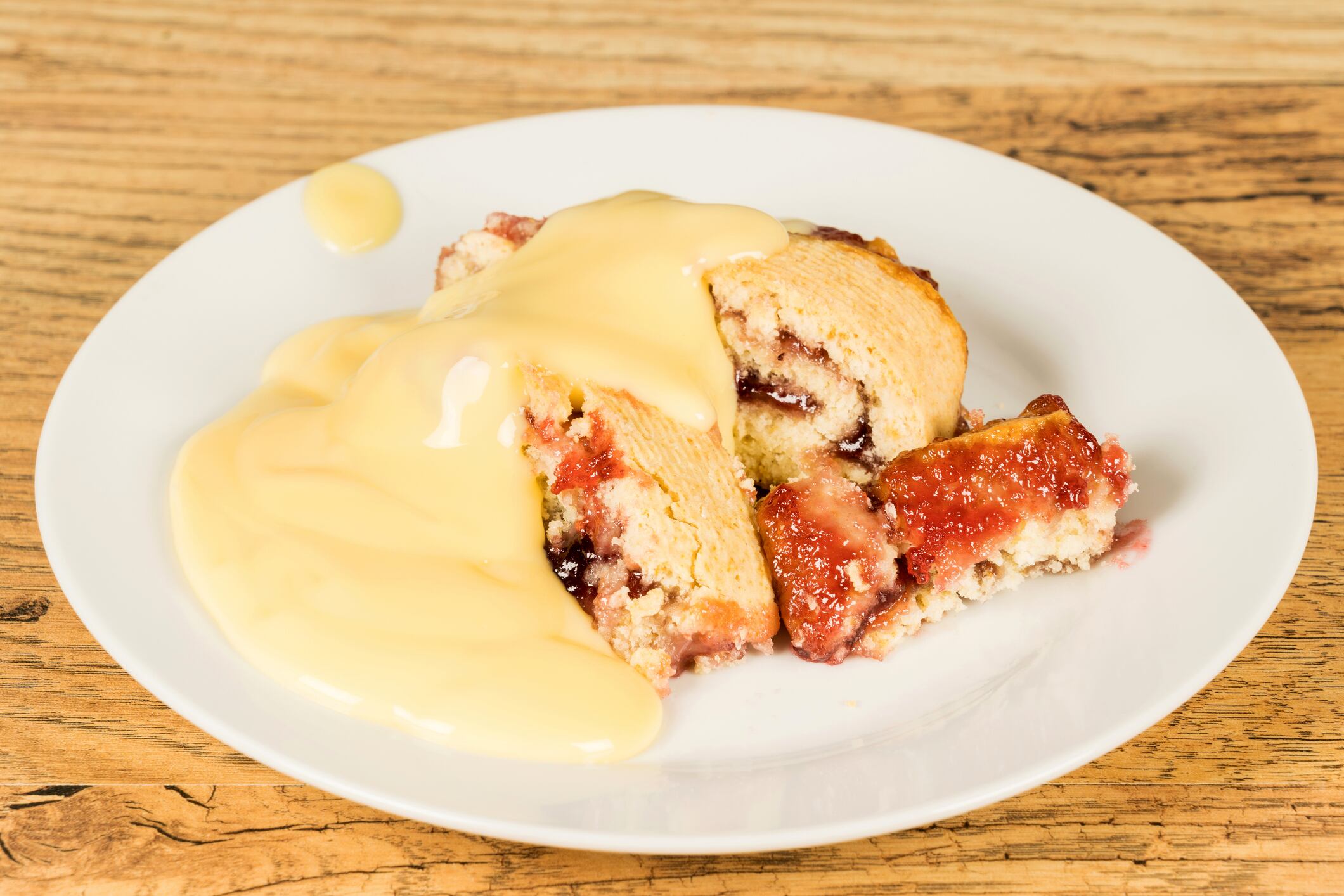 Jam roly poly dessert with custard