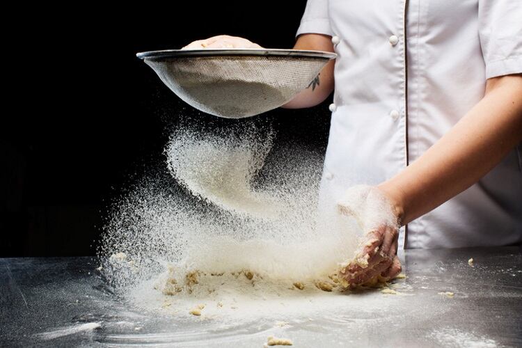 Adding flour to dough