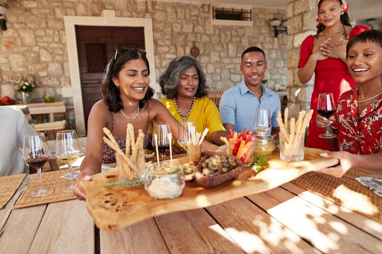 Family-around-table-enjoying-snacks-Klaus-Vedfeldt.jpg